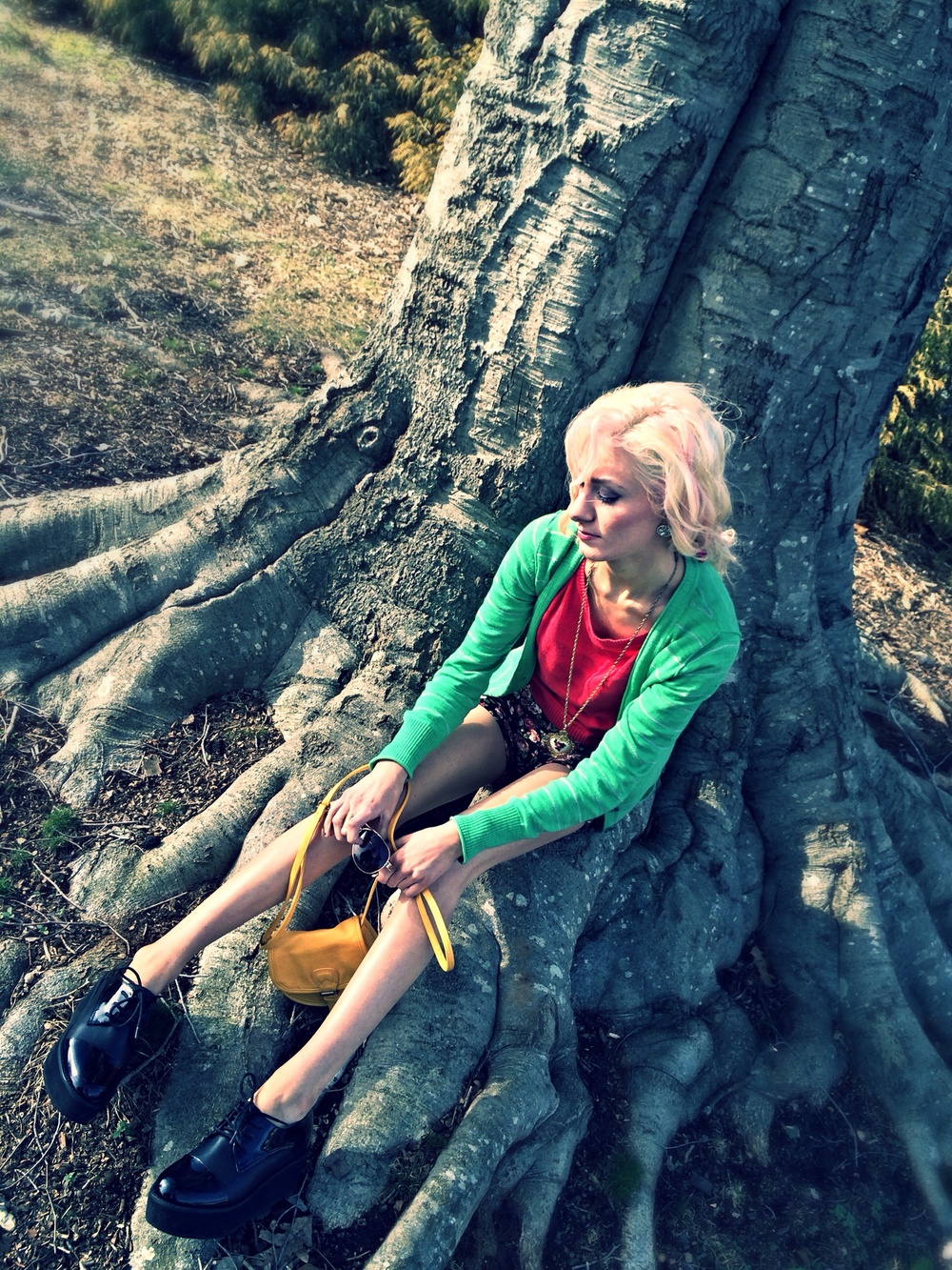 North Carolina fashion and lifestyle blogger Jessica Linn wearing a green cardigan from Target, a pink sweater and floral high-waisted shorts from Forever21, and Steve Madden platform shoes.