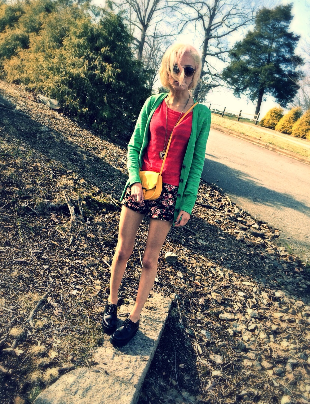 North Carolina fashion and lifestyle blogger Jessica Linn wearing a green cardigan from Target, a pink sweater and floral high-waisted shorts from Forever21, and Steve Madden platform shoes.