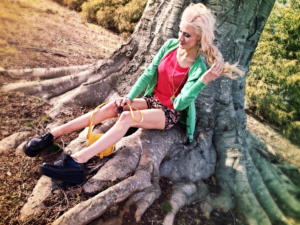 North Carolina fashion and lifestyle blogger Jessica Linn wearing a green cardigan from Target, a pink sweater and floral high-waisted shorts from Forever21, and Steve Madden platform shoes.