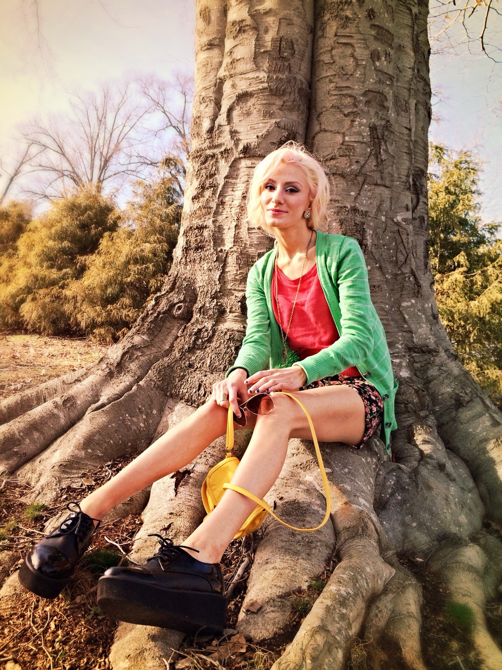 North Carolina fashion and lifestyle blogger Jessica Linn wearing a green cardigan from Target, a pink sweater and floral high-waisted shorts from Forever21, and Steve Madden platform shoes.