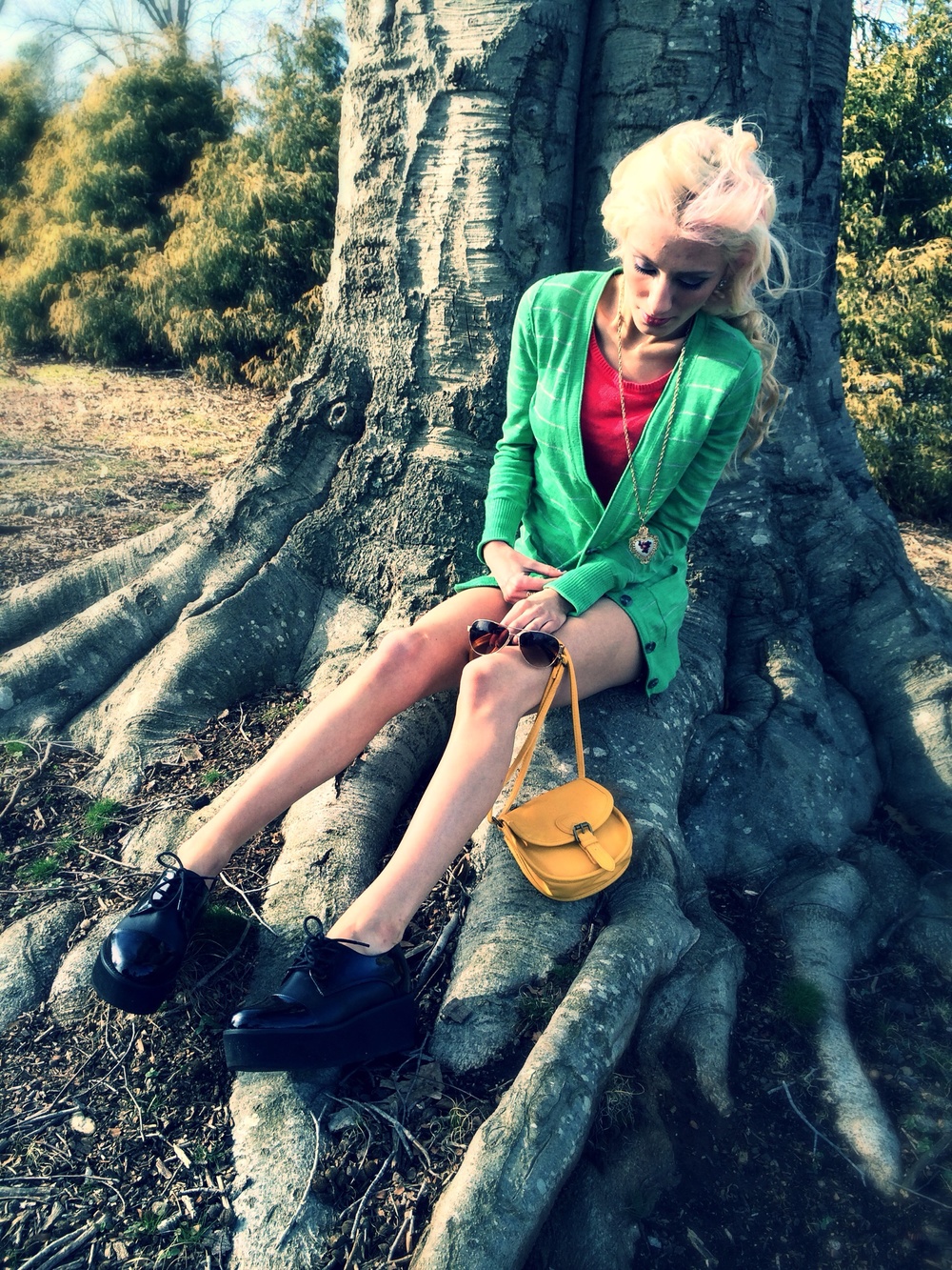 North Carolina fashion and lifestyle blogger Jessica Linn wearing a green cardigan from Target, a pink sweater and floral high-waisted shorts from Forever21, and Steve Madden platform shoes.