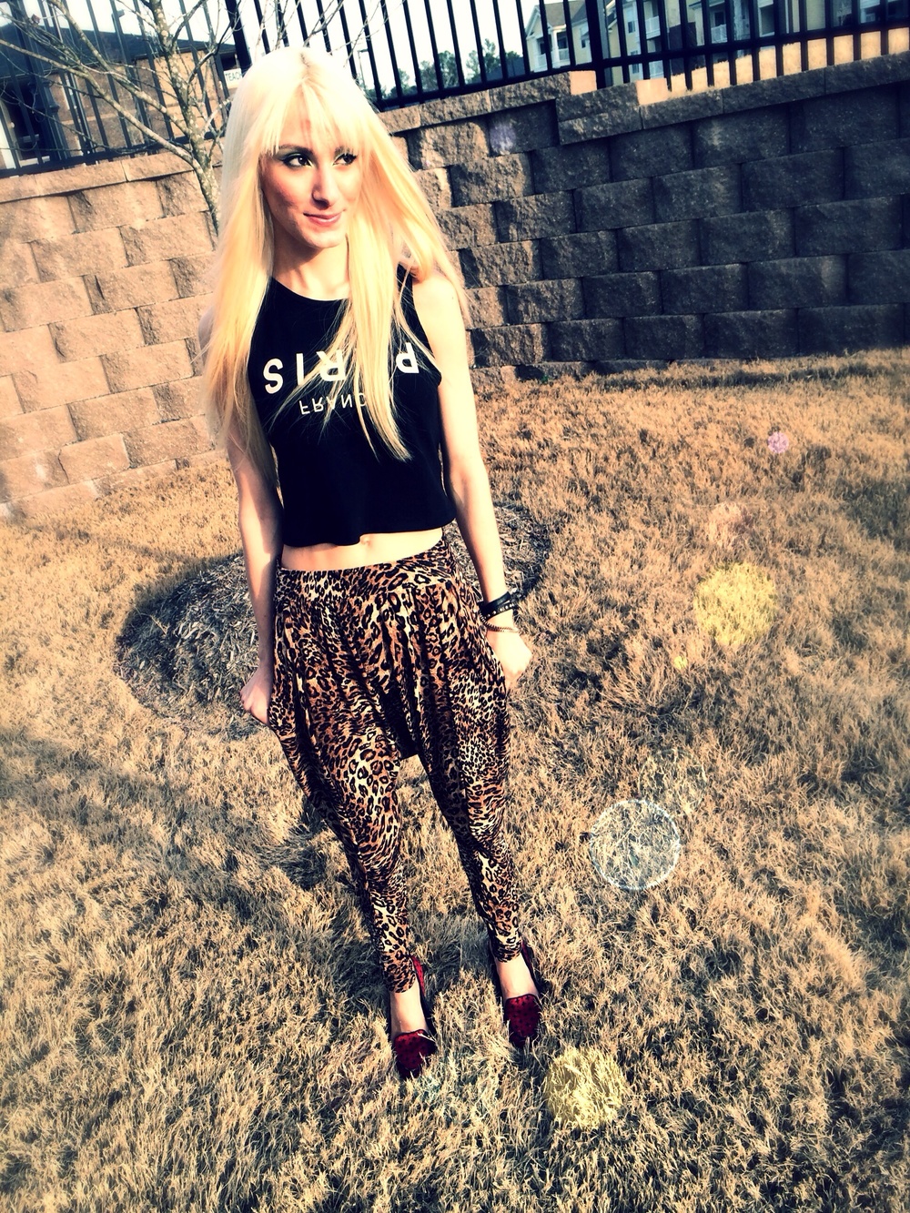 North Carolina fashion and lifestyle blogger Jessica Linn wearing leopard print harem pants, and a black tank top from Forever21, and red flats from GAP.
