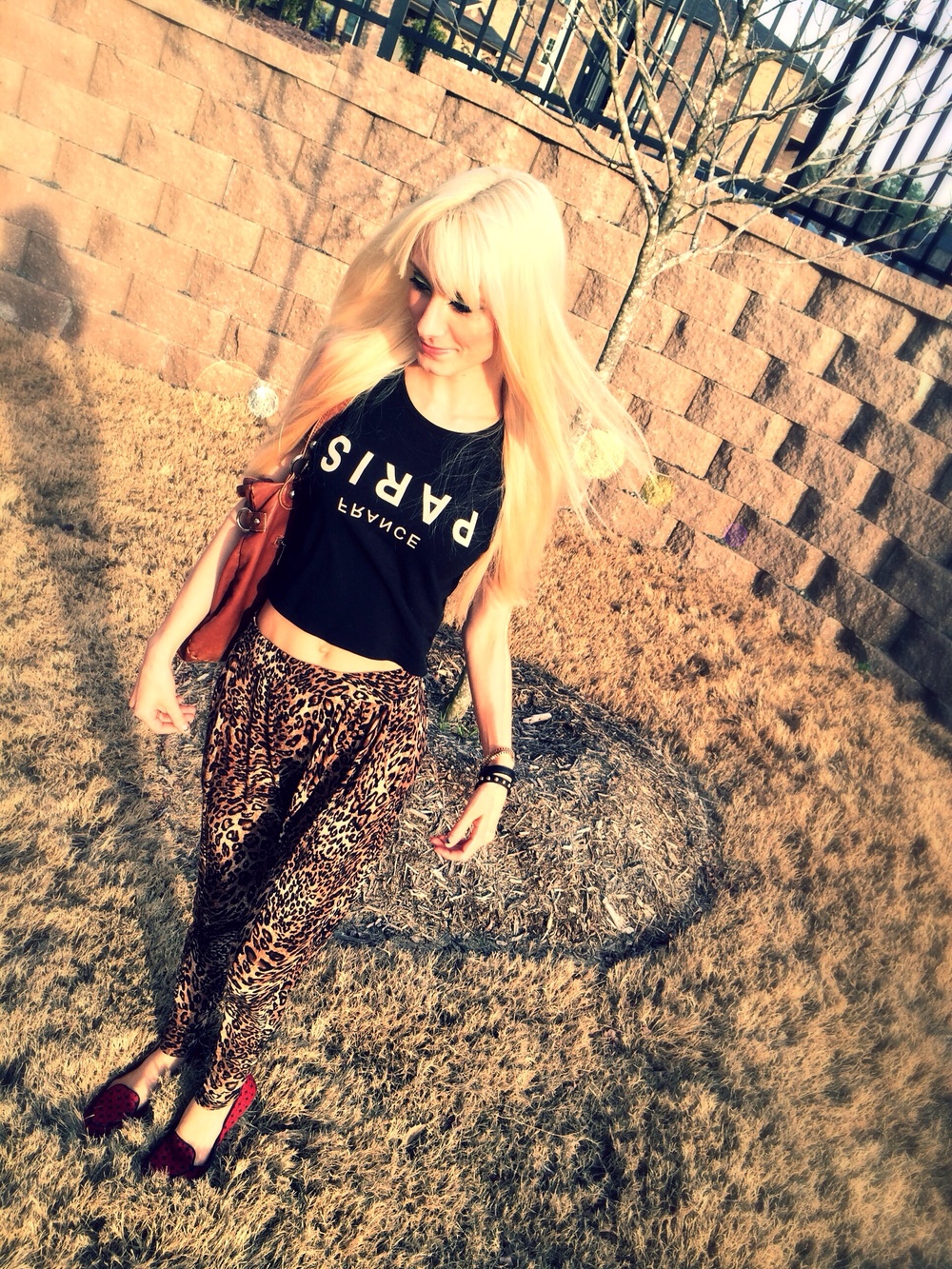 North Carolina fashion and lifestyle blogger Jessica Linn wearing leopard print harem pants, and a black tank top from Forever21, and red flats from GAP.