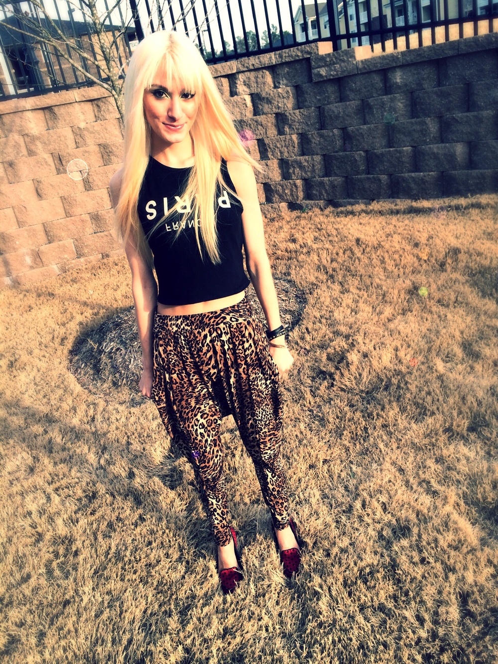 North Carolina fashion and lifestyle blogger Jessica Linn wearing leopard print harem pants, and a black tank top from Forever21, and red flats from GAP.