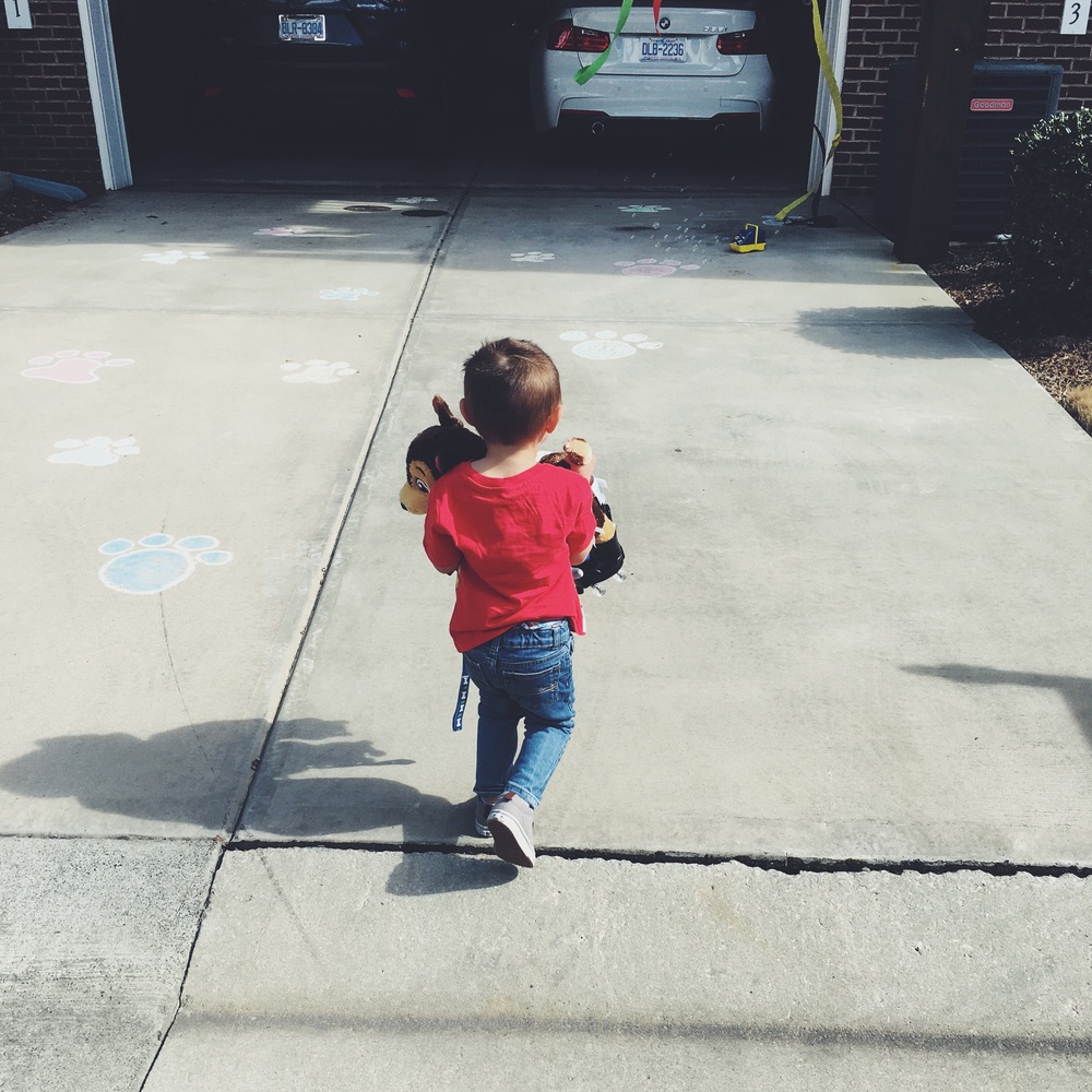 Chalk puppy paws leading into the garage when Grandma and Grandpa Linn brought him home from Build- A- Bear.  (Can you guess what stuffed animal he got?)  Hint: Paw Patrol.