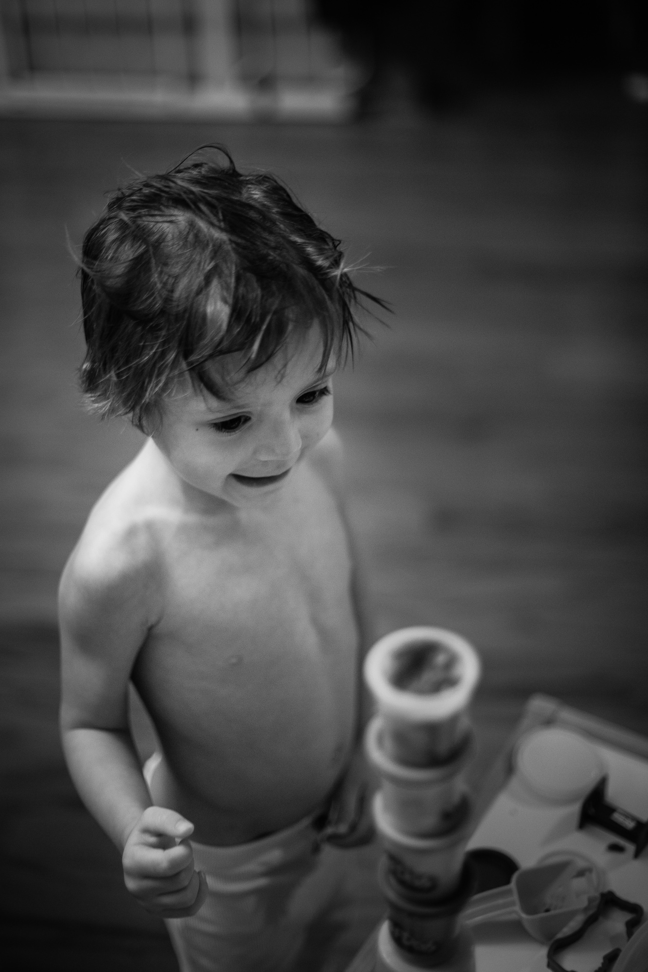 black and white photography. Kid playing with Hasbro Play-doh