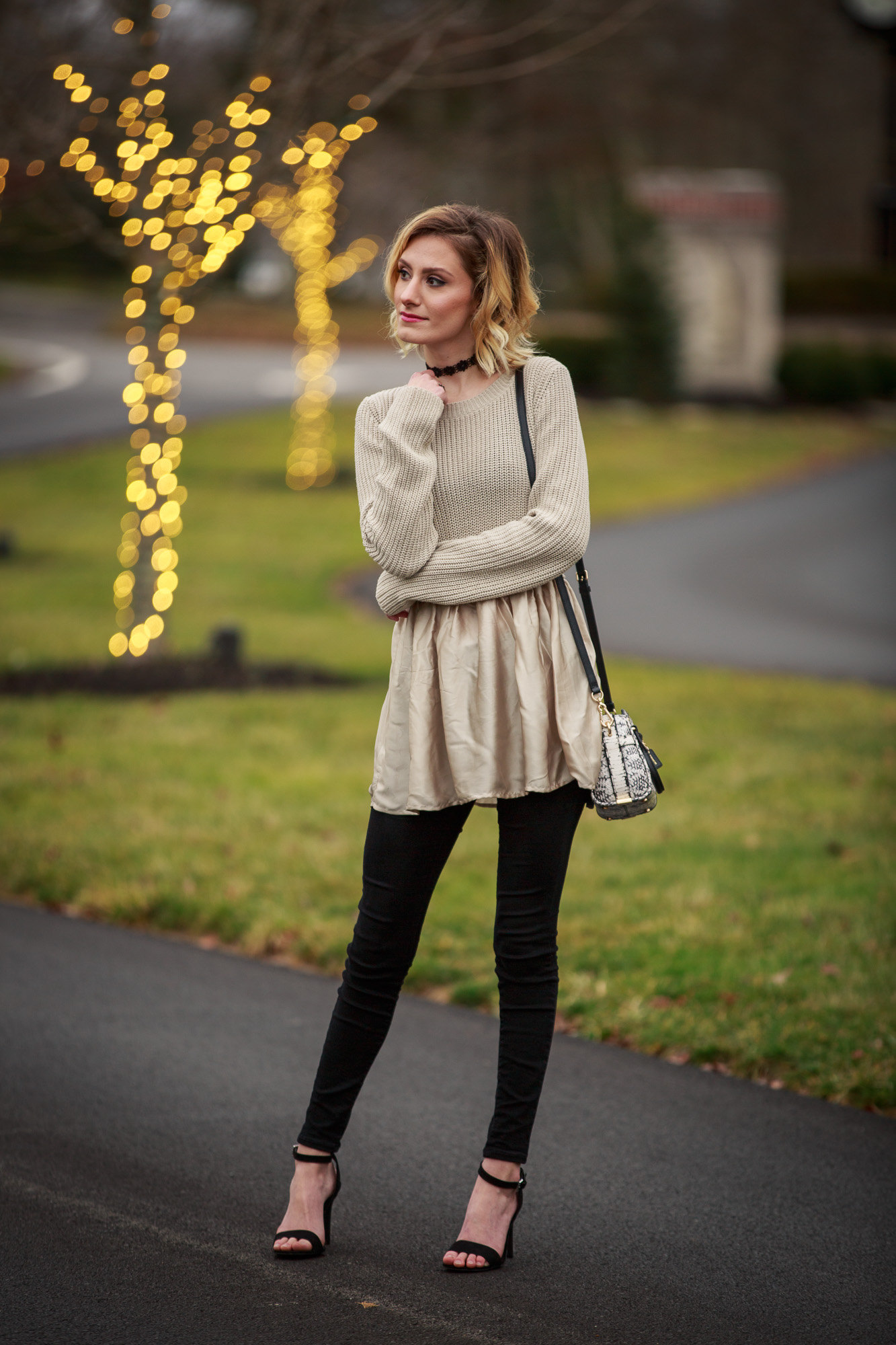 Fashion Blogger Jessica Linn from Linn Style wearing a sweater from Target and black skinny jeans from Old Navy with a pair of ASOS heels and a Coach purse.