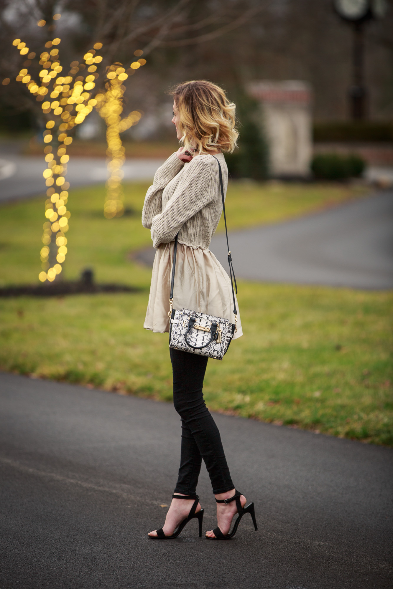 Fashion Blogger Jessica Linn from Linn Style wearing a sweater from Target and black skinny jeans from Old Navy with a pair of ASOS heels and a Coach purse.