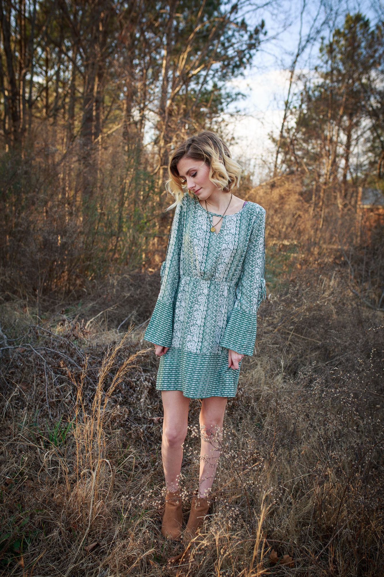 Lifestyle blogger Jessica Linn from Linn Style wearing a green patterned dress from Ross and Forever21 boots