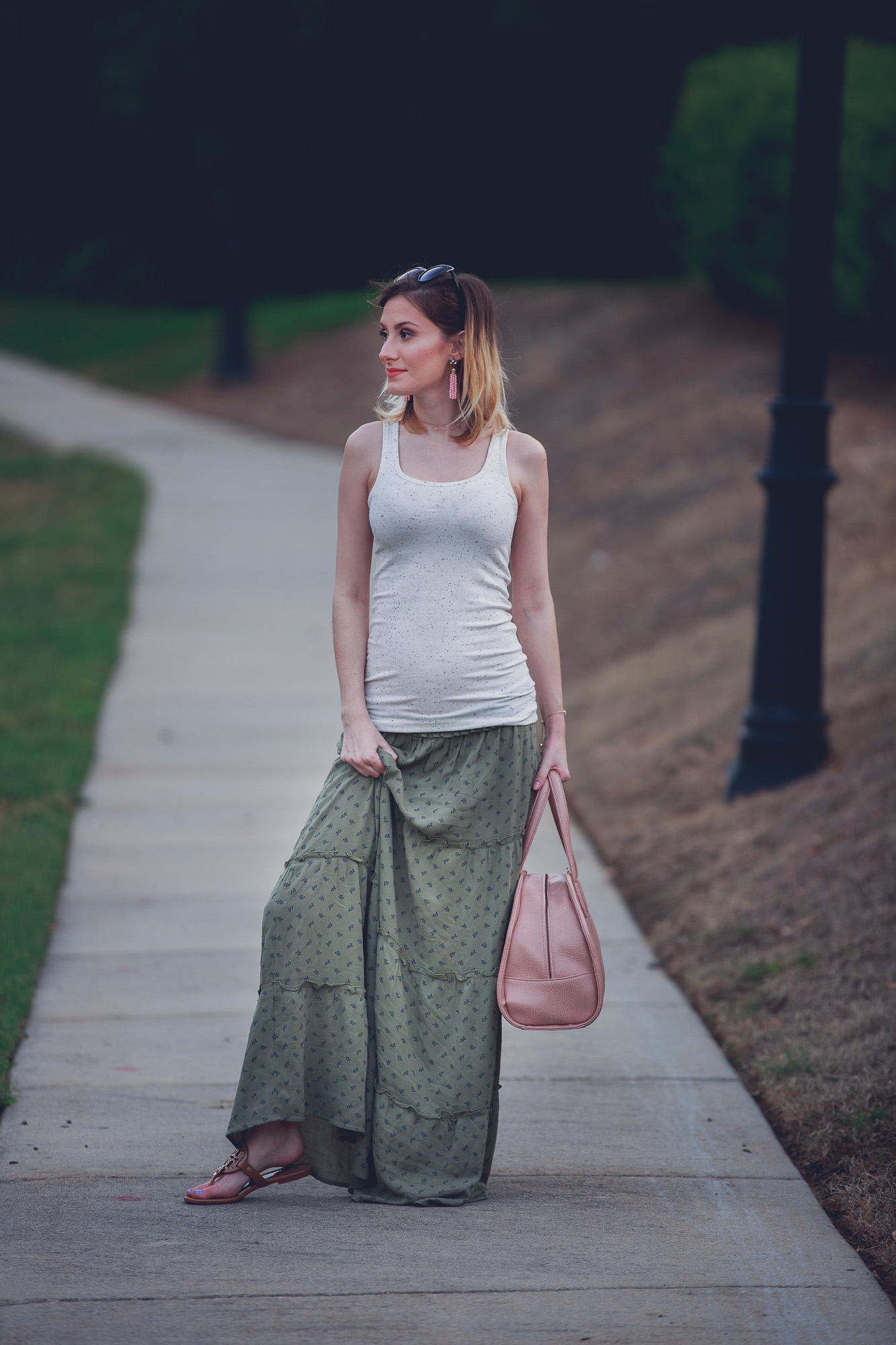 Jessica Linn from the lifestyle and fashion blog Linn Style wearing a green maxi skirt from Target, and tan tank top from Target, Baublebar earrings, a Kendra Scott bracelet, Charming Charlie sunglasses and carrying a Matt and Nat purse. 17 weeks pregnant maternity pregnancy clothes and style.