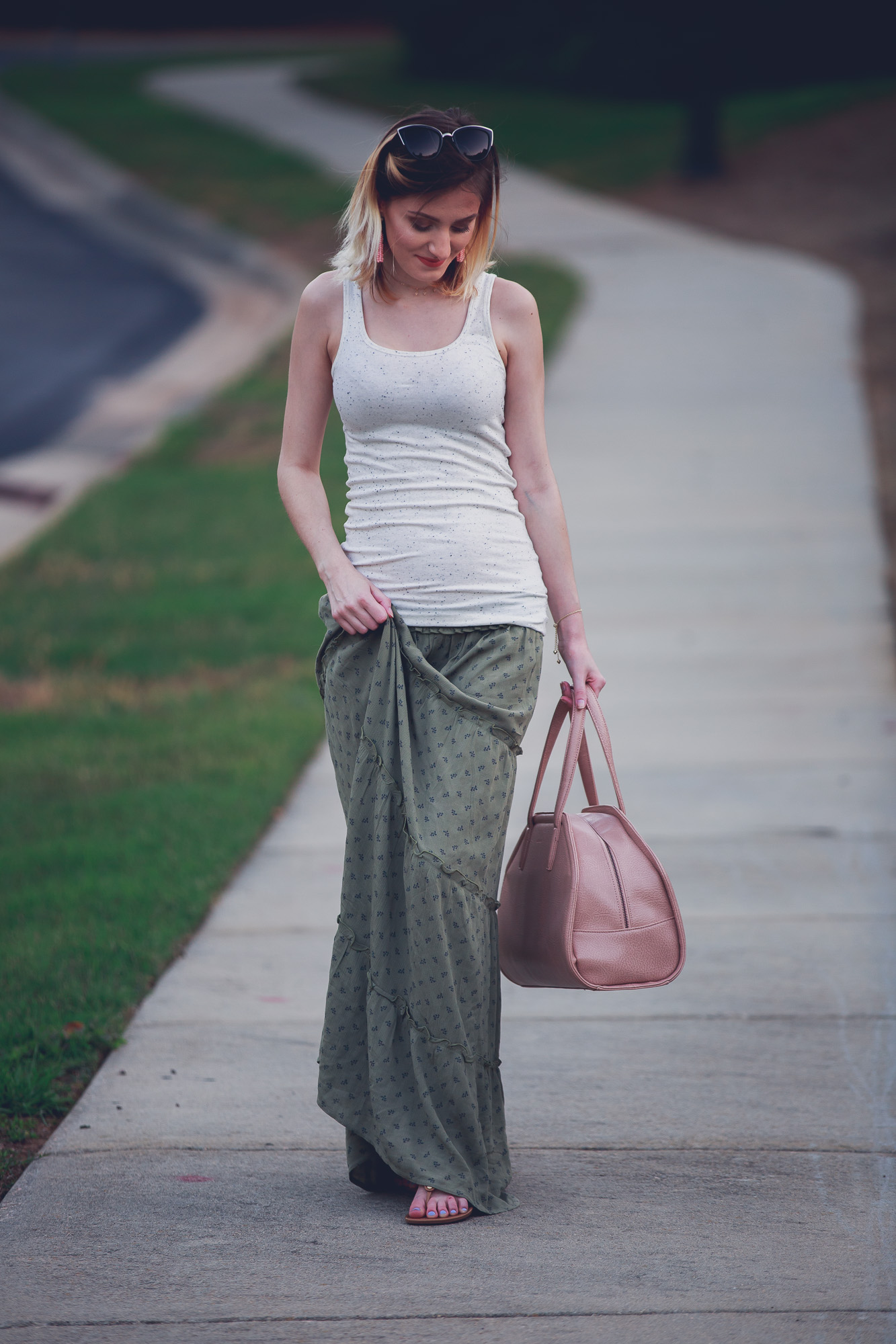 Jessica Linn from the lifestyle and fashion blog Linn Style wearing a green maxi skirt from Target, and tan tank top from Target, Baublebar earrings, a Kendra Scott bracelet, Charming Charlie sunglasses and carrying a Matt and Nat purse. 17 weeks pregnant maternity pregnancy clothes and style. Tory Burch sandals