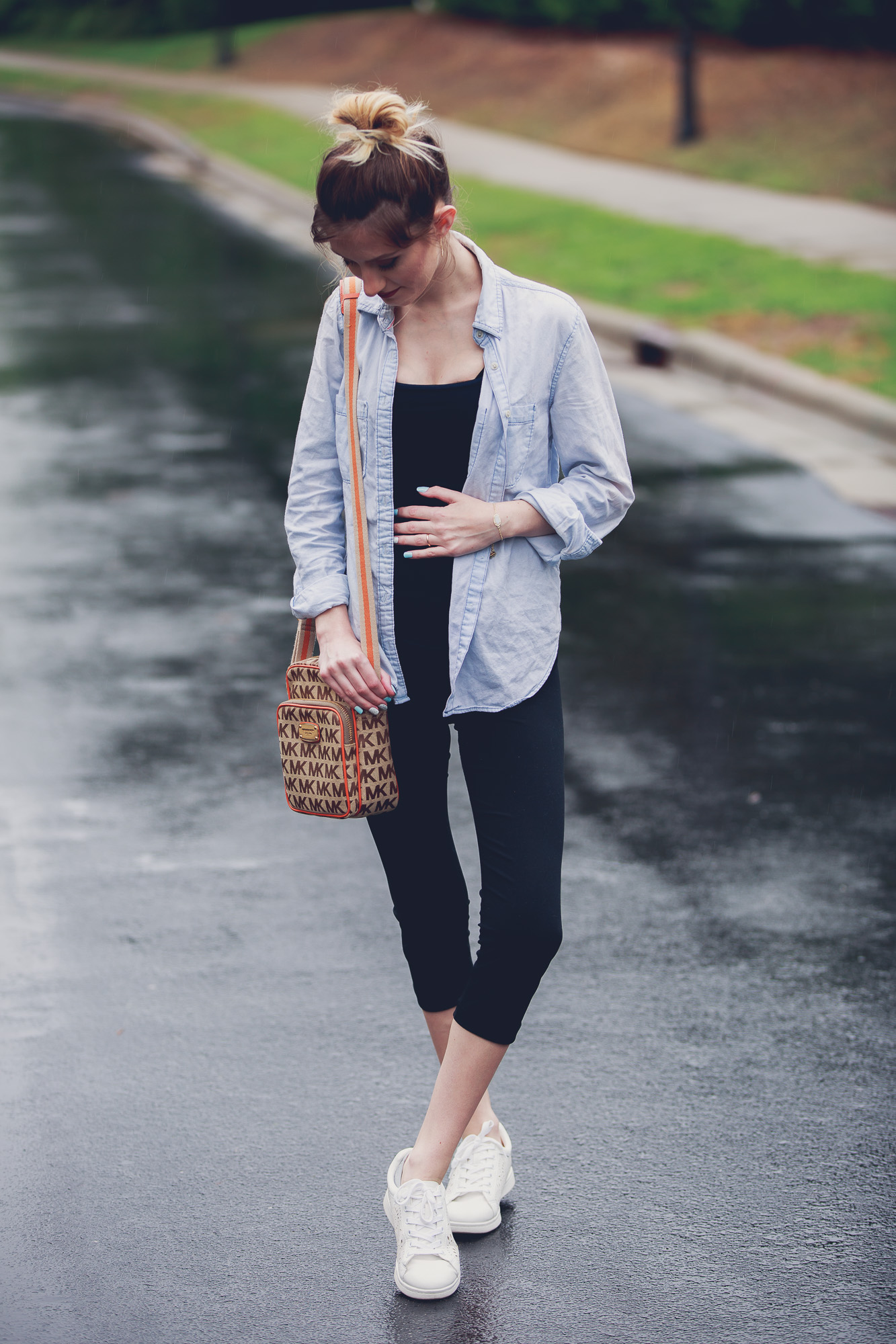 Fashion and lifestyle blogger Jessica Linn from Linn Style wearing a casual outfit: Target maternity leggings, an aeropostale tank top, and chambray button up, Target tennis shoes, Charming Charlie's earrings, and a Michael Kors purse in Cary North Carolina