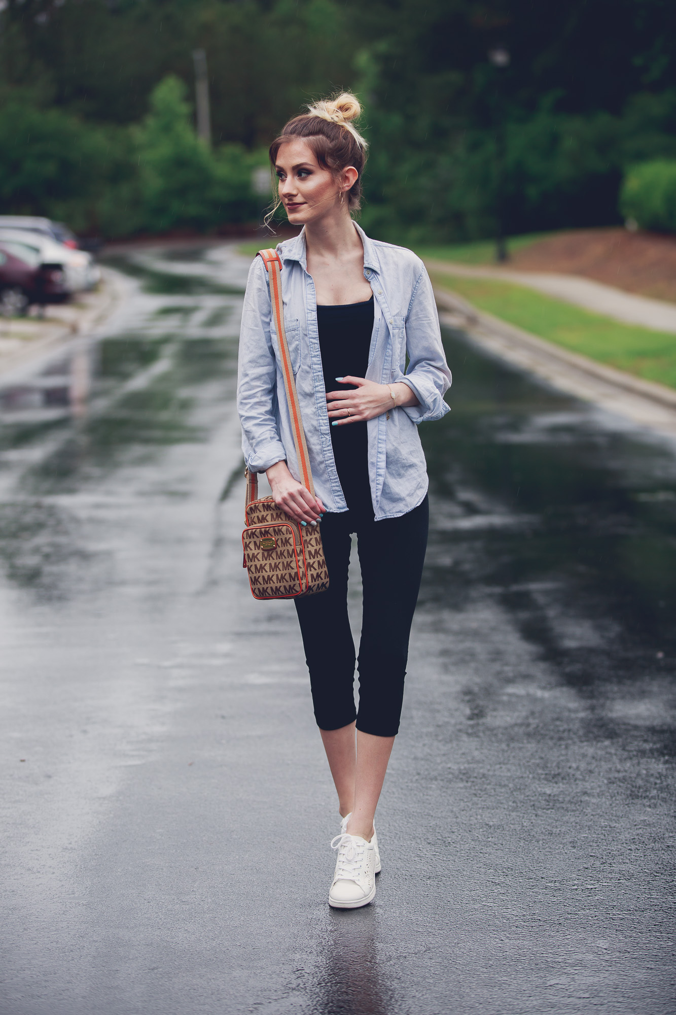 Fashion and lifestyle blogger Jessica Linn from Linn Style wearing a casual outfit: Target maternity leggings, an aeropostale tank top, and chambray button up, Target tennis shoes, Charming Charlie's earrings, and a Michael Kors purse in Cary North Carolina