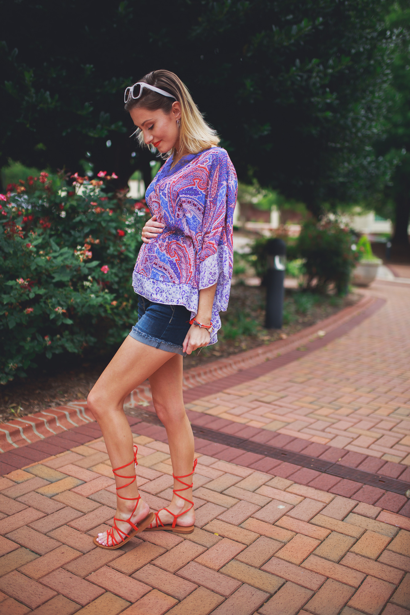 Lifestyle, fashion, and beauty blogger and vlogger, Jessica Linn, from Linn Style wearing a Paisley shear top with maternity shorts and Forever21 sandals and Charming Charlie's accessories.