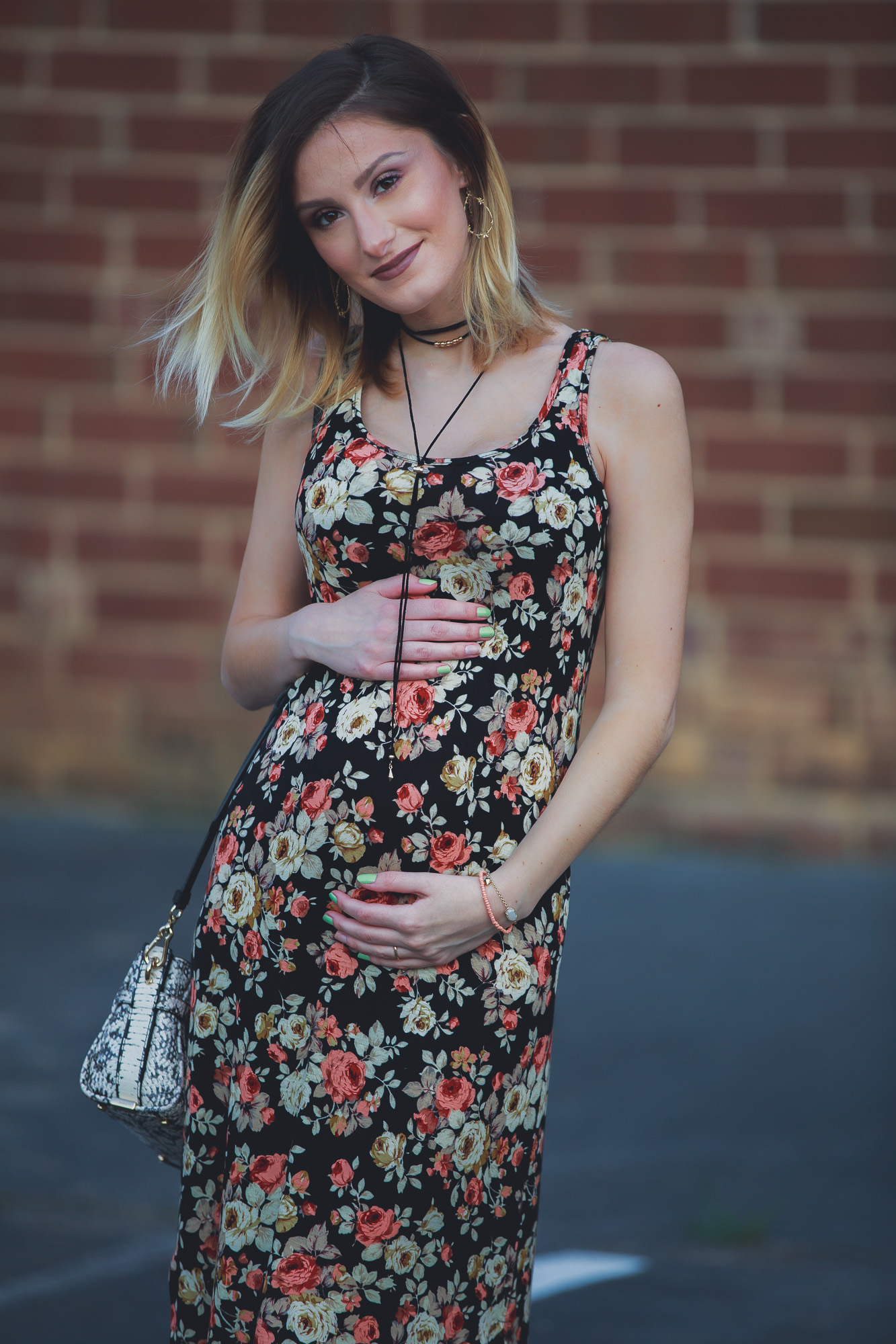 Lifestyle, fashion, and beauty blogger / vlogger Jessica Linn wearing a floral black maxi dress, Tory Burch sandals, a Coach purse, and earrings from CY Design Studio in Cary North Carolina on Linn Style