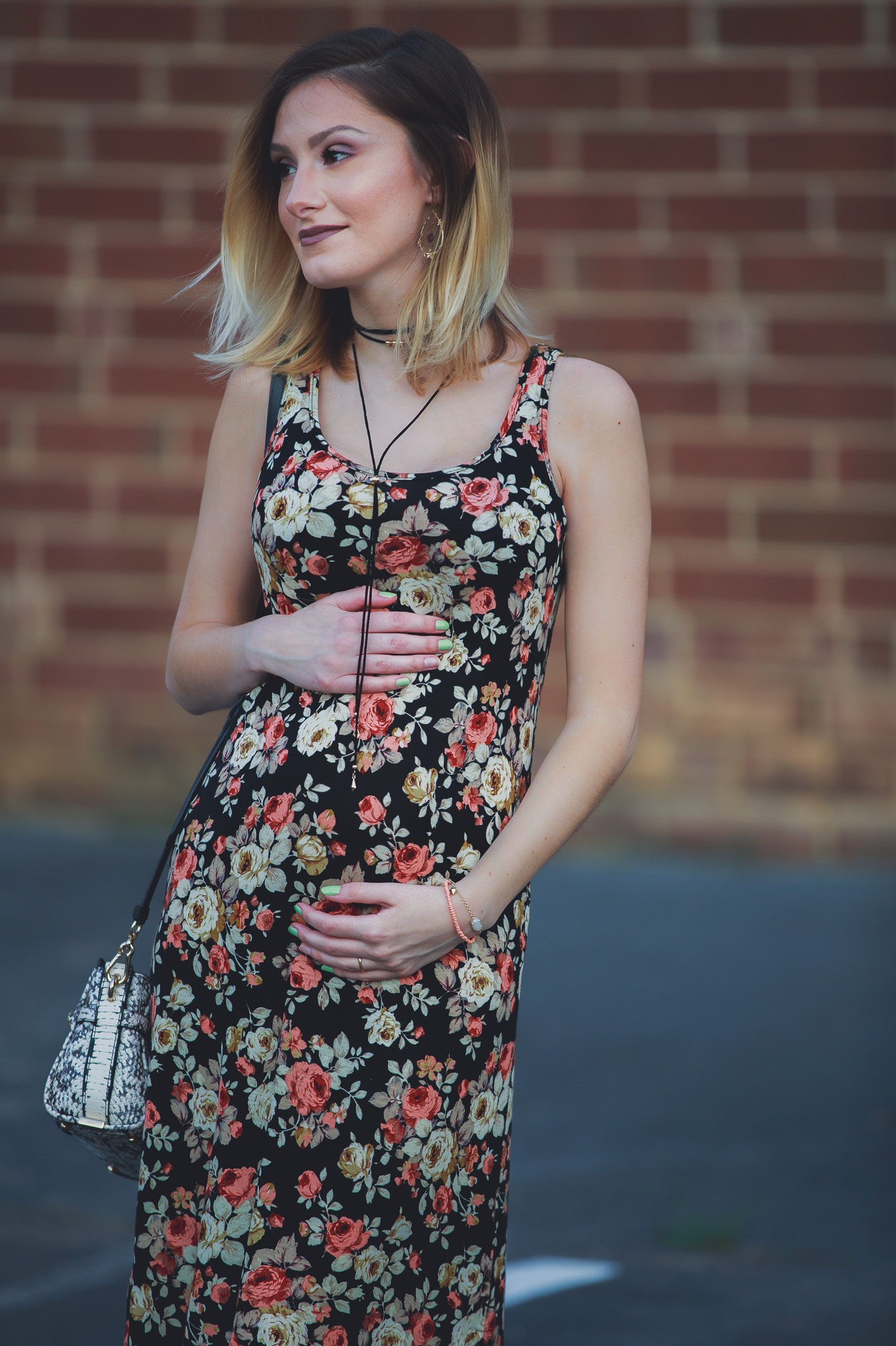 Lifestyle, fashion, and beauty blogger / vlogger Jessica Linn wearing a floral black maxi dress, Tory Burch sandals, a Coach purse, and earrings from CY Design Studio in Cary North Carolina on Linn Style