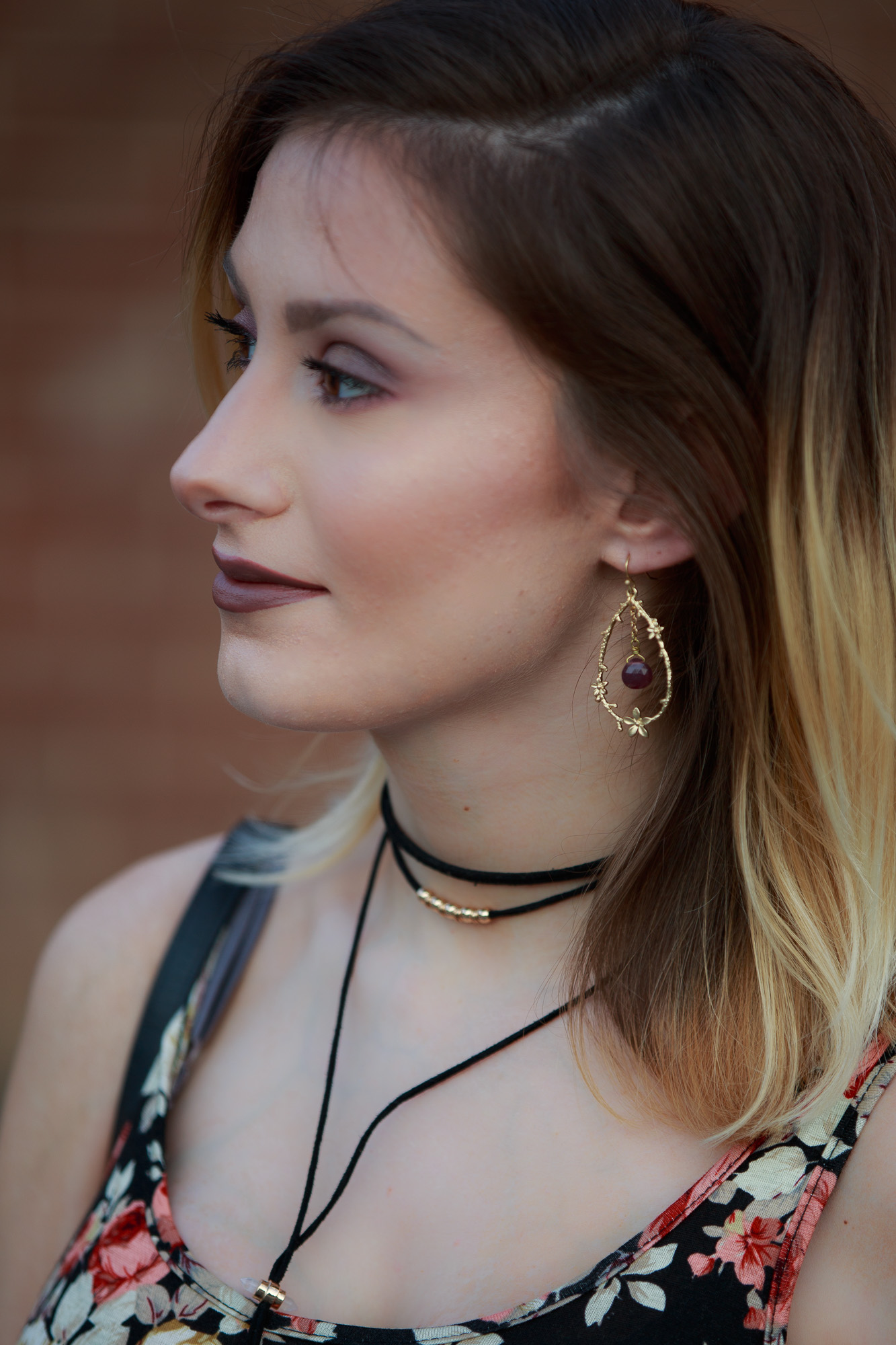 Lifestyle, fashion, and beauty blogger / vlogger Jessica Linn wearing a floral black maxi dress, Tory Burch sandals, a Coach purse, and earrings from CY Design Studio in Cary North Carolina on Linn Style