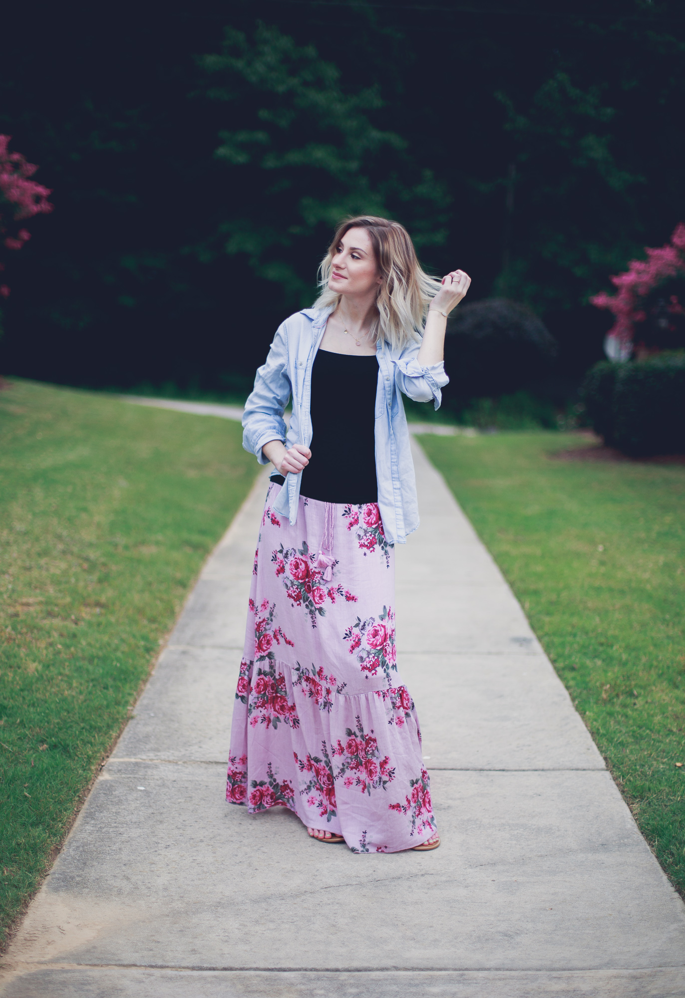 Lifestyle, fashion, and beauty blogger / vlogger Jessica Linn from Linn Style wearing a pink floral maxi skirt from Ross a simple black tank and unbuttoned chambray with Tory Burch Sandals. Maternity Fashion Maternity Style