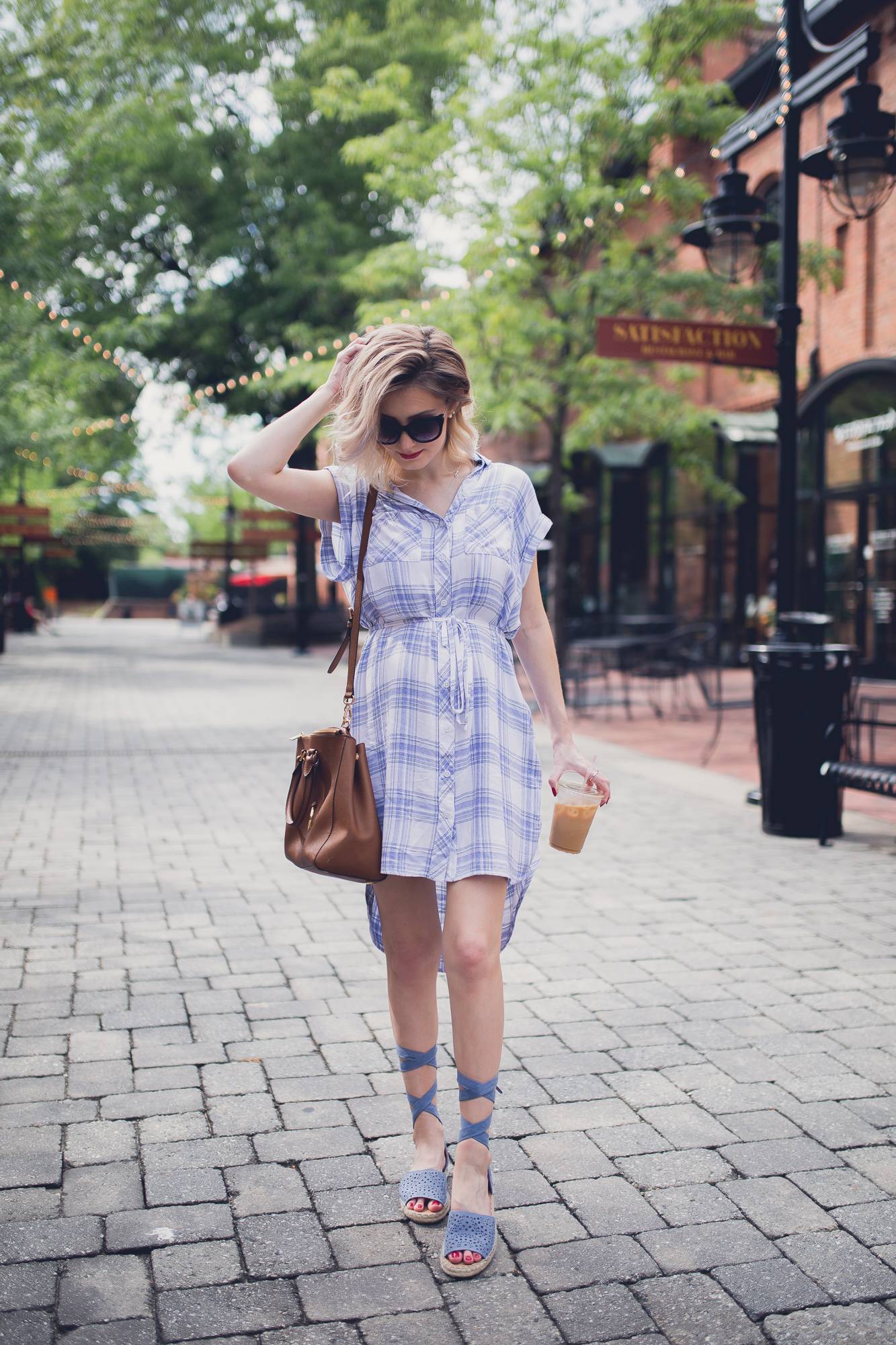 Fashion, lifestyle, and beauty blogger/ vlogger Jessica Linn on Linn Style wearing a blue and white plaid button up t-shirt dress from Ross, lace up blue sandals from Report footwear, and jewelry from local Cary North Carolina business CY Design Studio and lipstick from locally made all natural organic lipstick from SumerReign Cosmetics by Ashley Summerville in Durham NC.