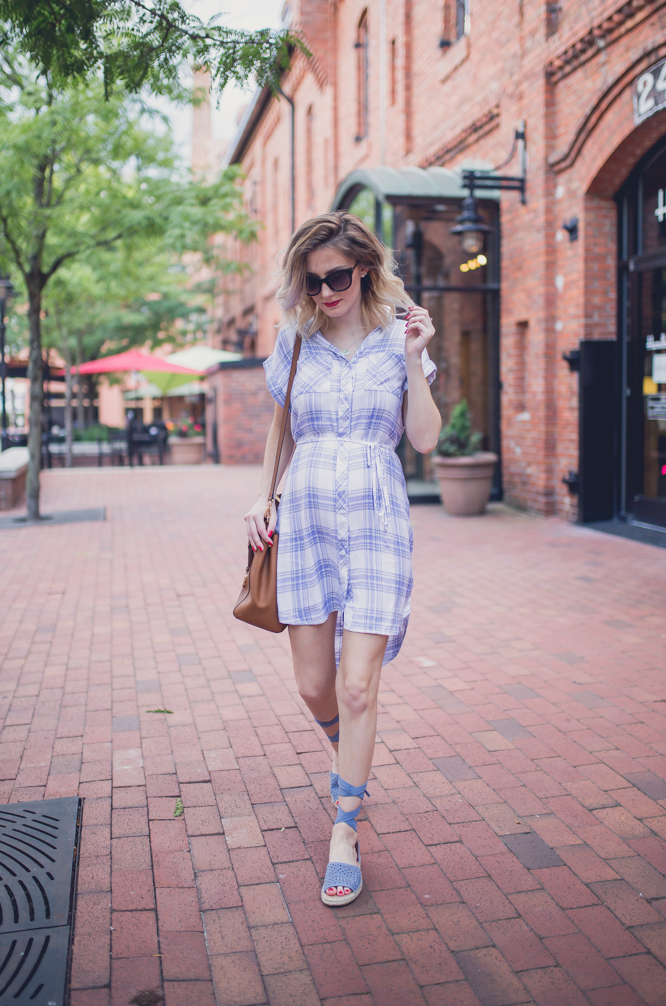Fashion, lifestyle, and beauty blogger/ vlogger Jessica Linn on Linn Style wearing a summer blue and white plaid button up t-shirt dress from Ross, lace up blue sandals from Report footwear, and jewelry from local Cary North Carolina business CY Design Studio and lipstick from locally made all natural organic lipstick from SumerReign Cosmetics by Ashley Summerville in Durham NC.