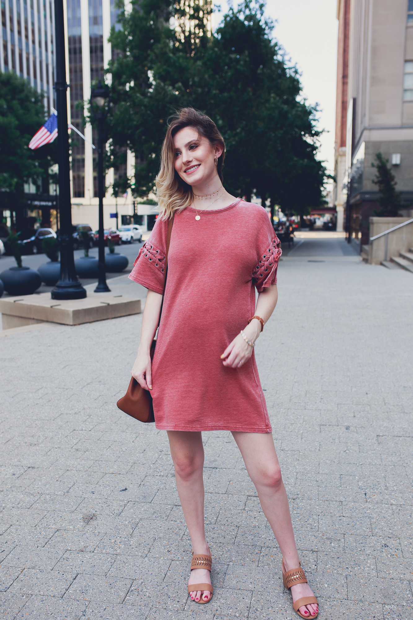Lifestyle Fashion and beauty blogger Jessica Linn from Linn Style wearing a Forever21 sweater dress and Michael Kors purse in downtown Raleigh North Carolina. Non-maternity maternity outfits.