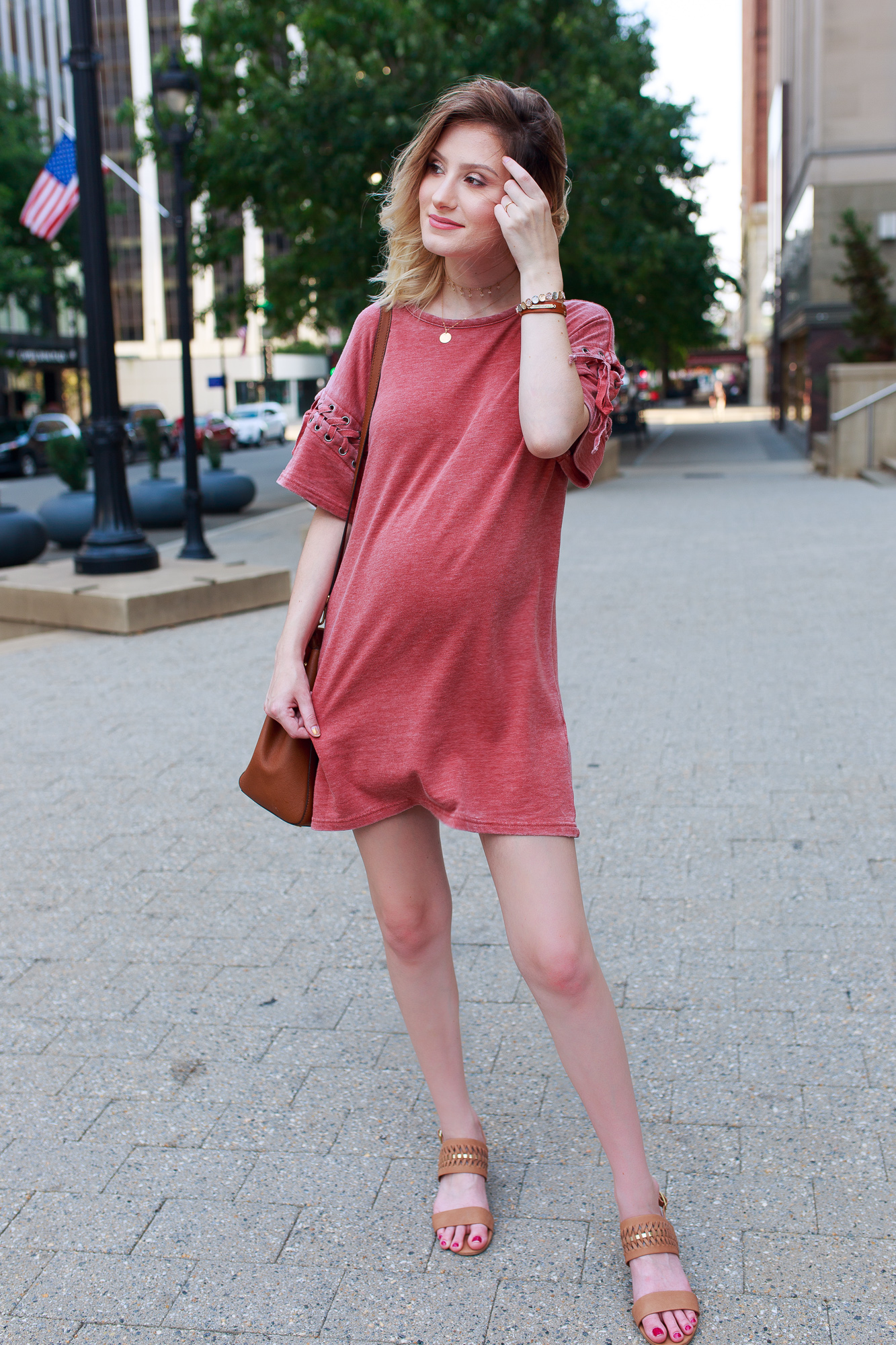 Lifestyle Fashion and beauty blogger Jessica Linn from Linn Style wearing a Forever21 sweater dress and Michael Kors purse in downtown Raleigh North Carolina. Non-maternity maternity outfits.