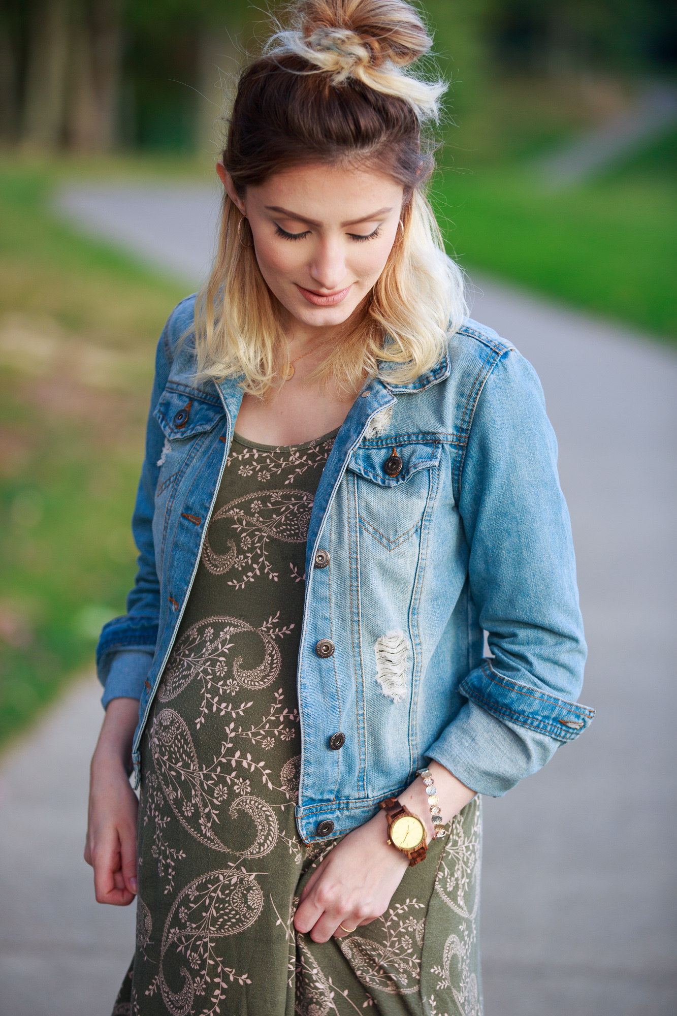 Lifestyle and fashion blogger Jessica Linn wearing a Charlotte Russe olive colored dress with a neutral paisley pattern, a denim jacket, thigh high socks, and Ralph Lauren boots. Perfect fall maternity outfit!