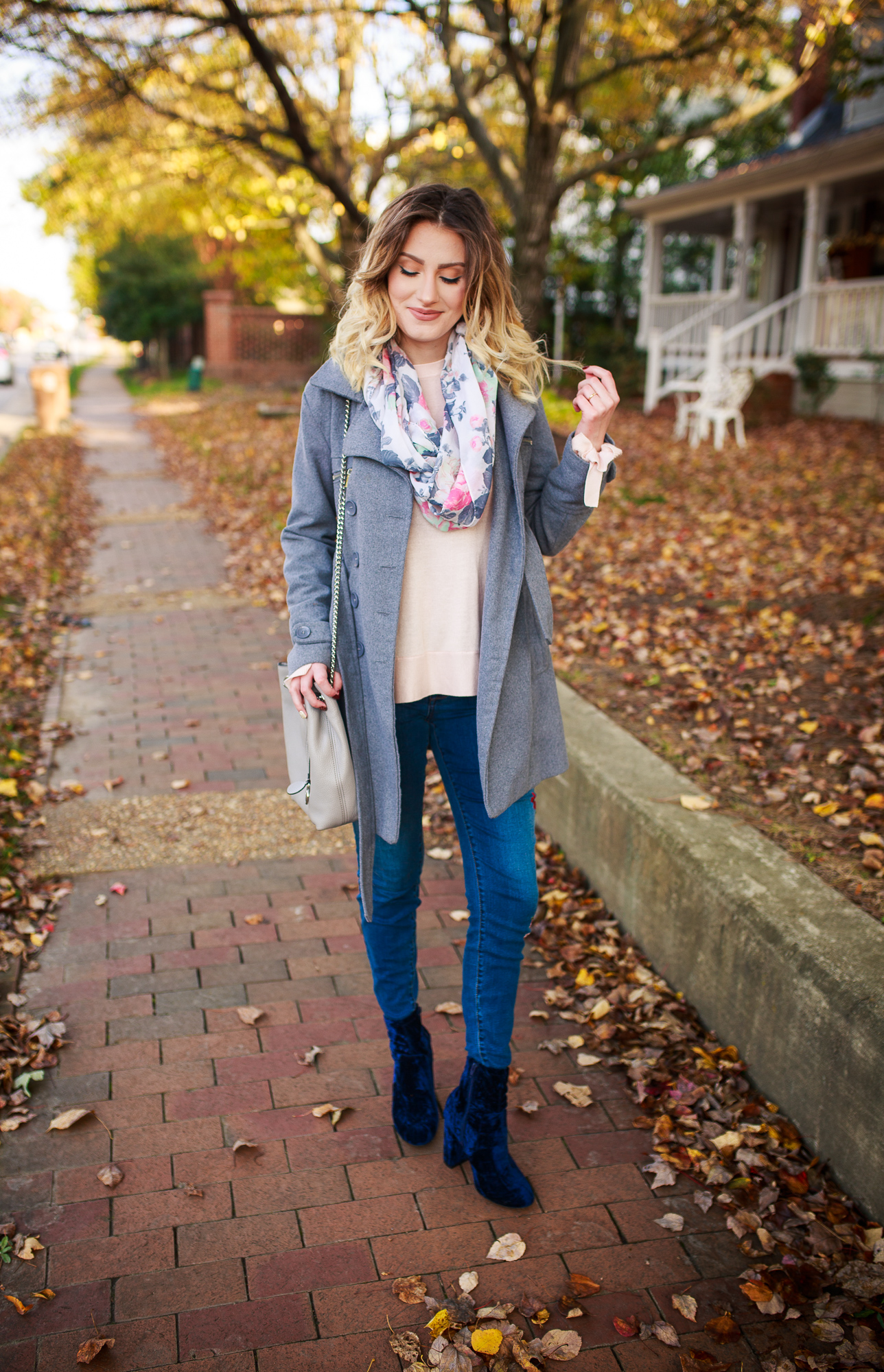 Fashion Trends- A New Day Clothing Brand From Target. Fashion and lifestyle blogger Jessica Linn from Linn Style wearing a pink ruffle bell sleeve sweater, floral embroidered skinny jeans, a gray peacoat, blue velvet booties, and a floral Scarf from World Market. Carrying a pearl gray Michael Kors purse
