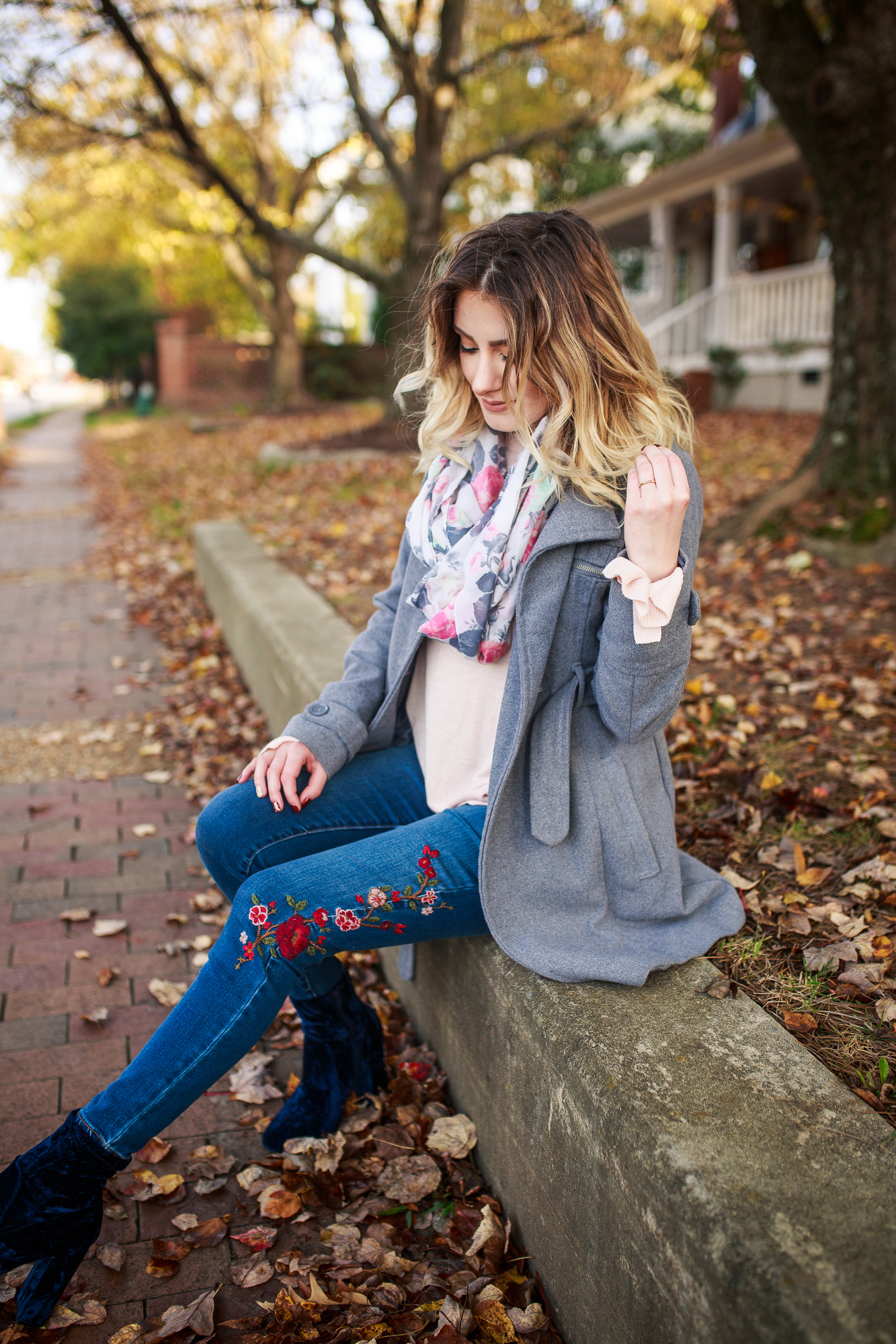 A New Day Clothing Brand From Target. Fashion and lifestyle blogger Jessica Linn from Linn Style wearing a pink ruffle bell sleeve sweater, floral embroidered skinny jeans, a gray peacoat, blue velvet booties, and a floral Scarf from World Market. Carrying a pearl gray Michael Kors purse