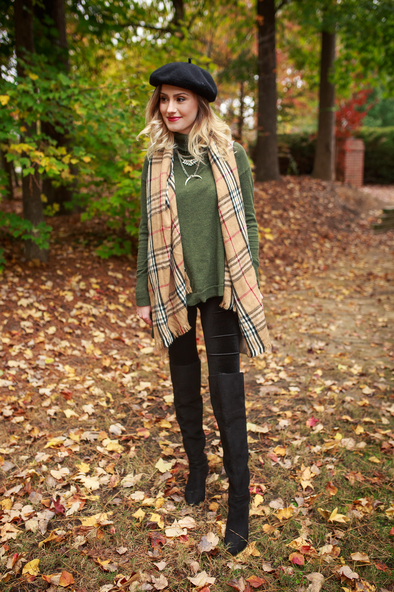 Fashion and lifestyle blogger Jessica Linn from Linn Style wearing a Burberry style scarf, dark green sweater, black velvet leggings from A New Day from Target, a black beret, and over the knee boot from NineWest