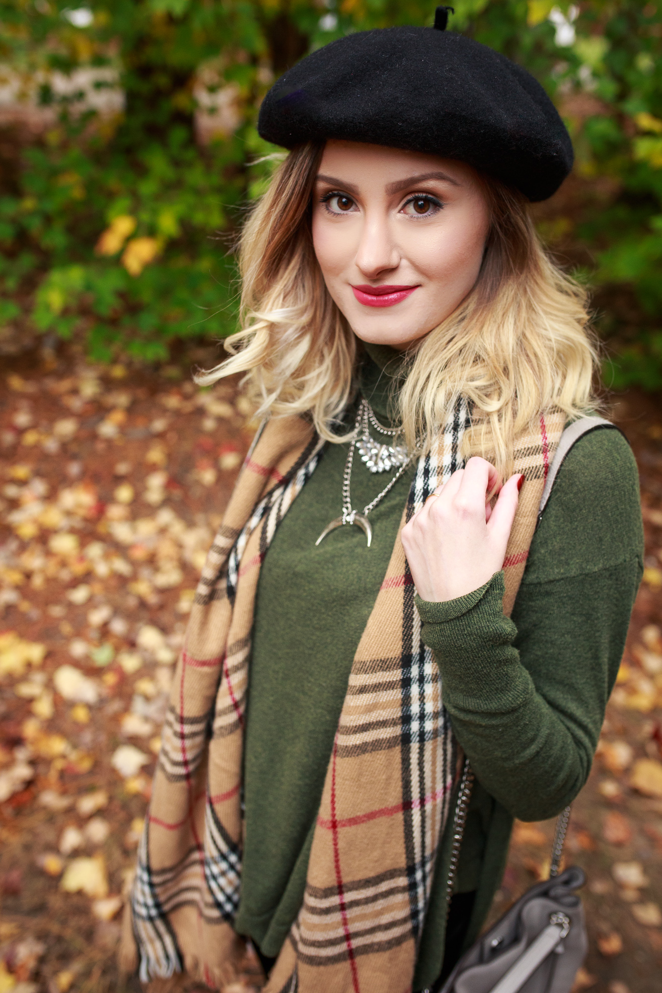 Fashion and lifestyle blogger Jessica Linn from Linn Style wearing a Burberry style scarf, dark green sweater, black velvet leggings from A New Day from Target, a black beret, and over the knee boot from NineWest