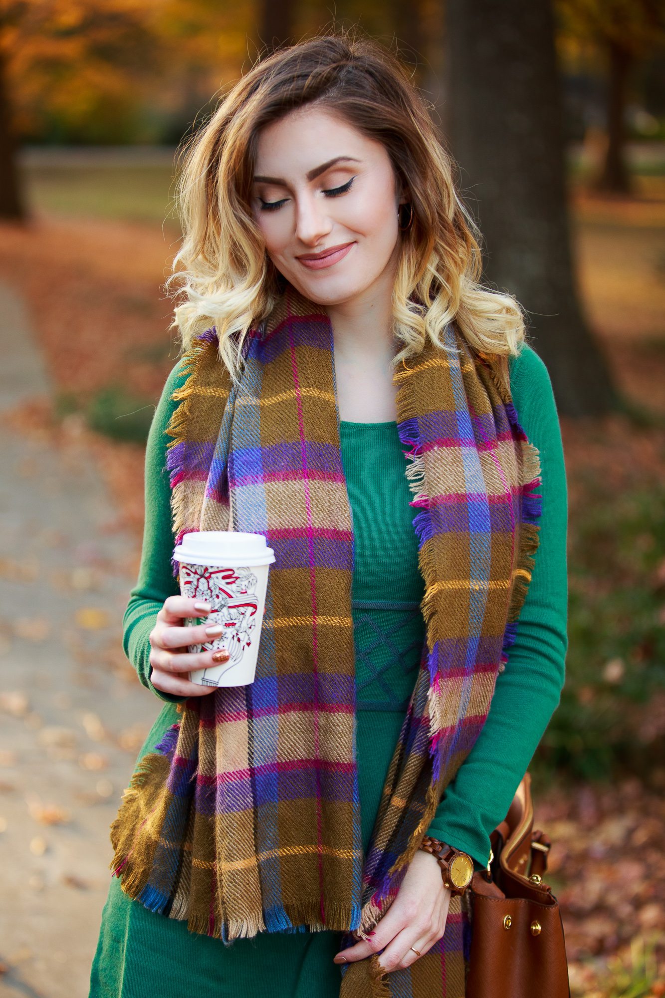 North Carolina fashion and lifestyle blogger Jessica Linn wearing a sweater dress from Aventura. Aventura clothes are made from organic sustainable materials promoting sustainable fashion. Also wearing fringe booties from Forever21, a green plaid scarf from Target, and a Michael Kors purse and a JORD wood watch.