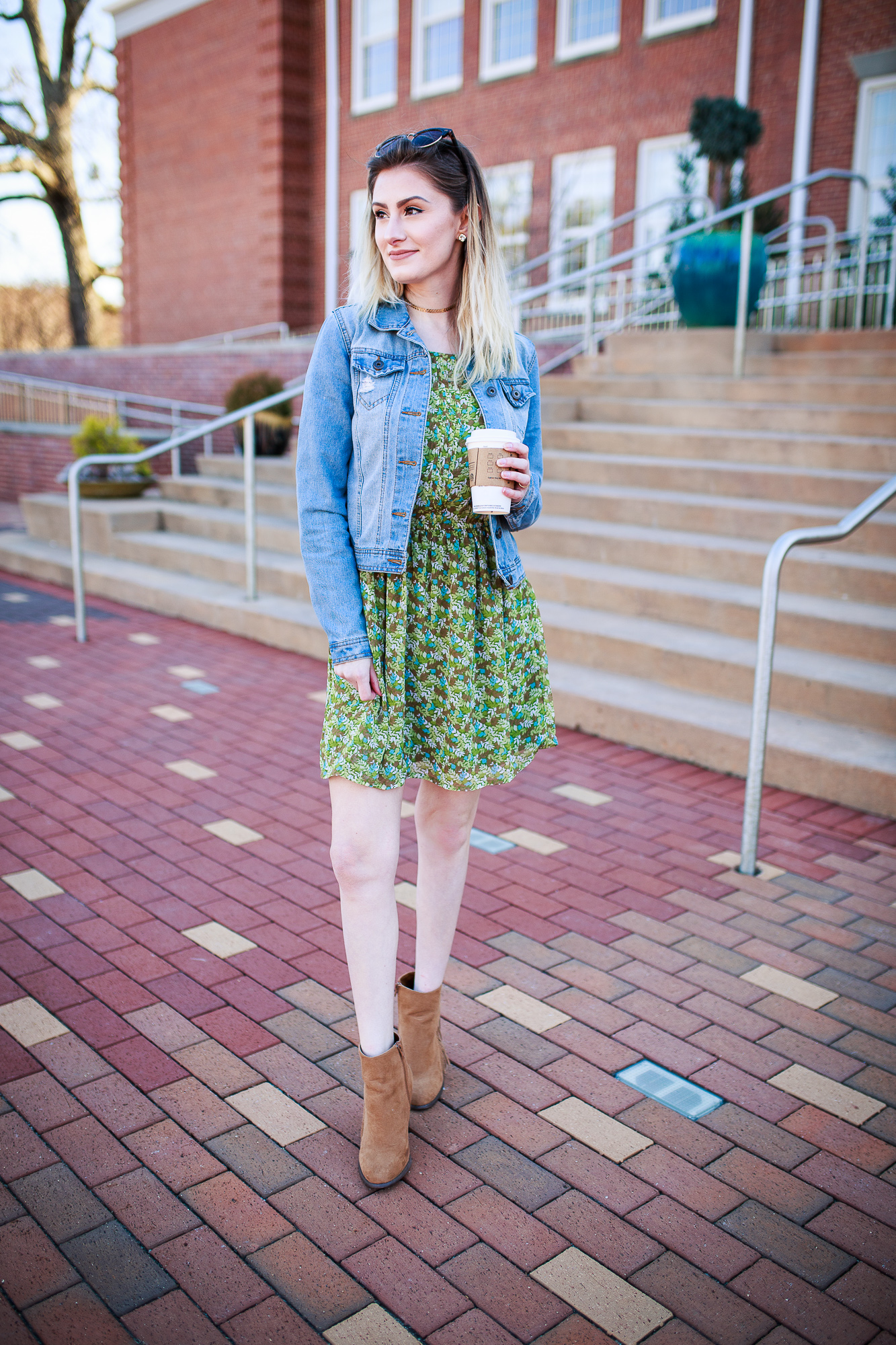 North Carolina fashion and lifestyle blogger Jessica Linn wearing her version of spring trends. A floral print dress from Charming Charlie, fringe faux suede booties from Forever21, a denim jacket from Ross, and a gold choker from local Cary NC business CY Design Studio.