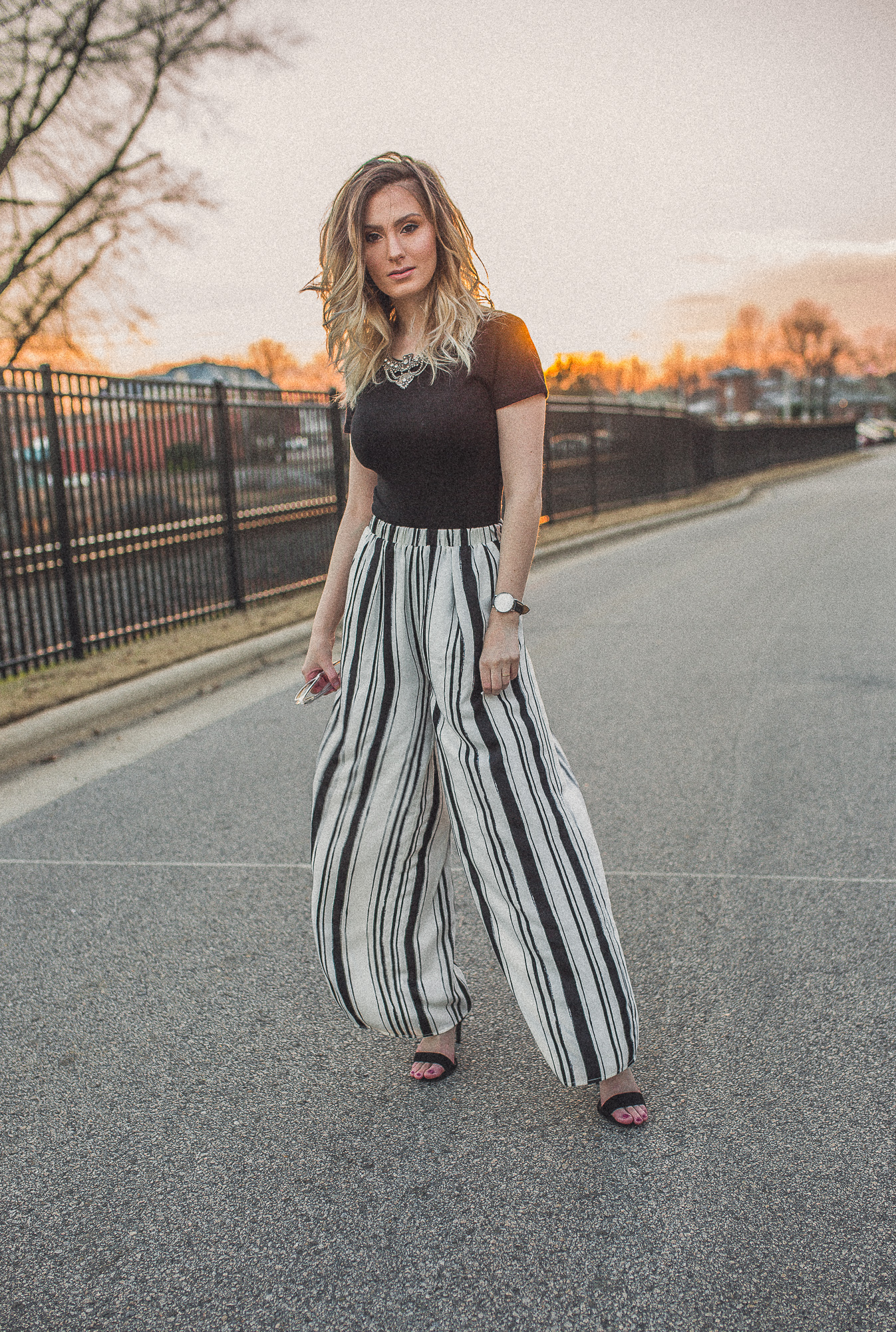 North Carolina fashion and lifestyle blogger Jessica Linn from Linn Style wearing a black Forever21 bodysuit and Forever21 black and white stripe palazzo pants. Paired with black faux suede strap sandal heels from ASOS, a Baublebar statement necklace from Target, a Welly Merck Roma watch, and Charming Charlie white sunglasses