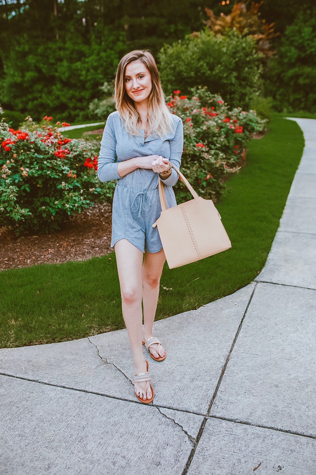The cutest summer romper! North Carolina fashion and lifestyle blogger Jessica Linn wearing the seasons hottest trend: Rompers and jumpsuits are every stylish persons go to look this summer. This little gray romper can be purchased on copperbloom.com. Jessica styled the romper with beaded sandals, a beige tote, and teal Baublebar earrings from Target. Photo editing using Christine Andrews (Hello Fashion Blog) mobile presets.