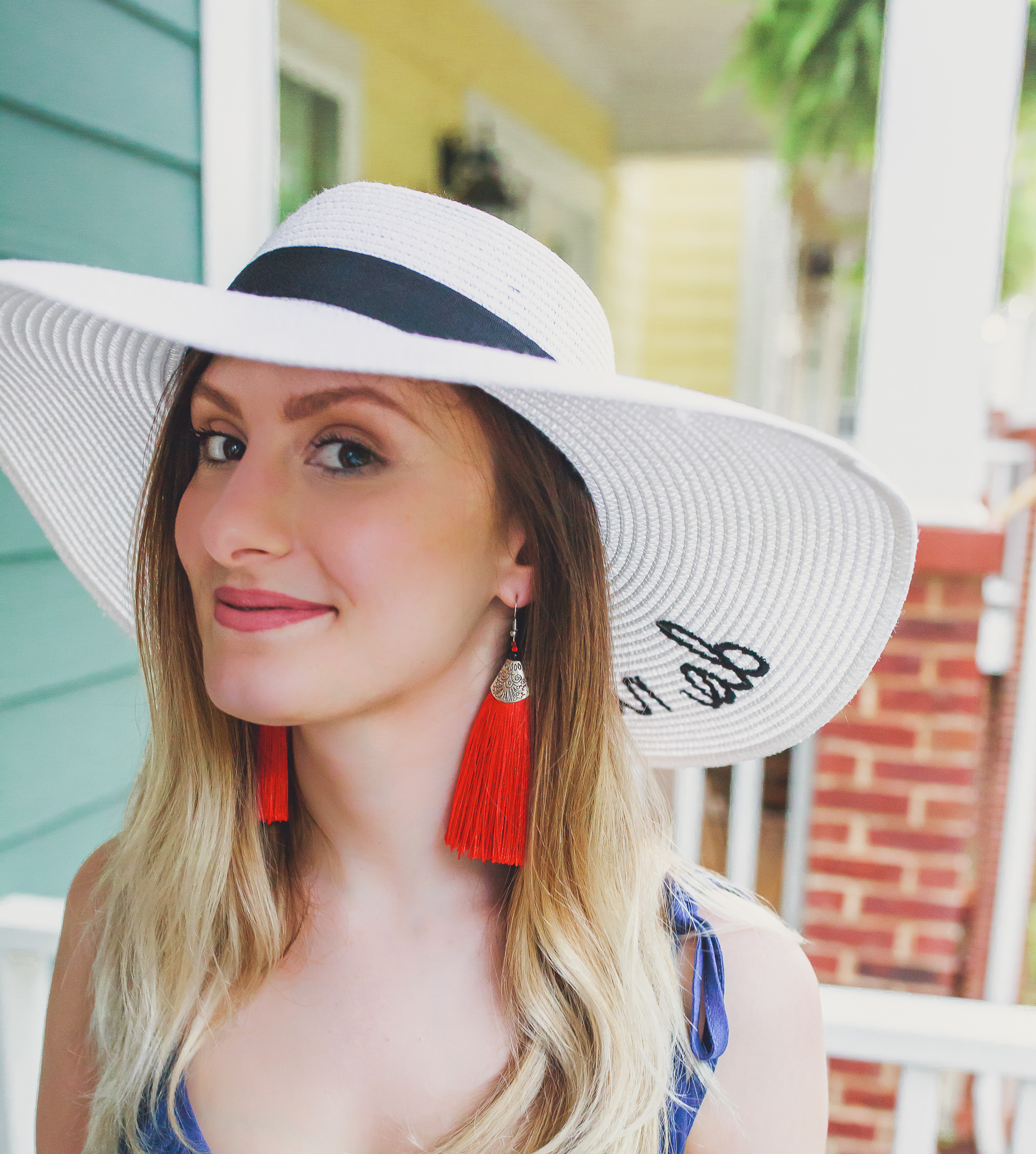 What to Wear in The 4th of July | Fashion and lifestyle blogger Jessica Linn showing some Independence Day outfit inspiration and a cute red white and blue outfit in collaboration with local North Carolina business, Southern Chique Boutique. Navy blue spaghetti strap dress from Southern Chique Boutique, red tassel earrings and "Do Not Disturb" sun hat from Copper Bloom, purse by Universal Thread from Target, and sandals from Ross.