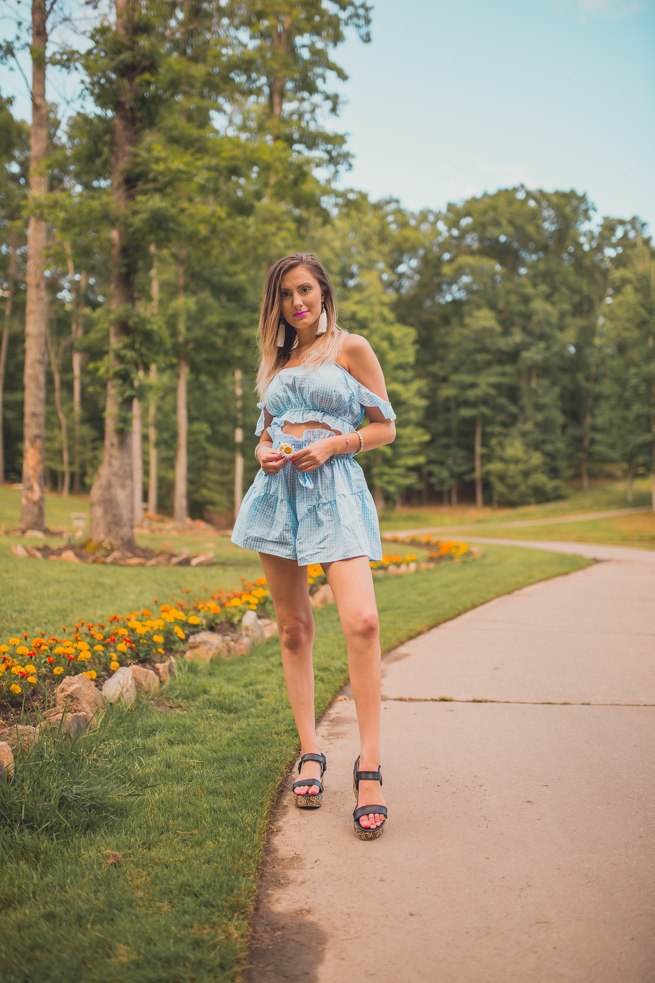 Gingham summer trend styled by North Carolina fashion and lifestyle blogger Jessica Linn from Linn Style. Two piece shorts and crop top gingham set from online fashion boutique Copper Bloom, platform sandals from Target, and tassel statement earrings from Copper Bloom.