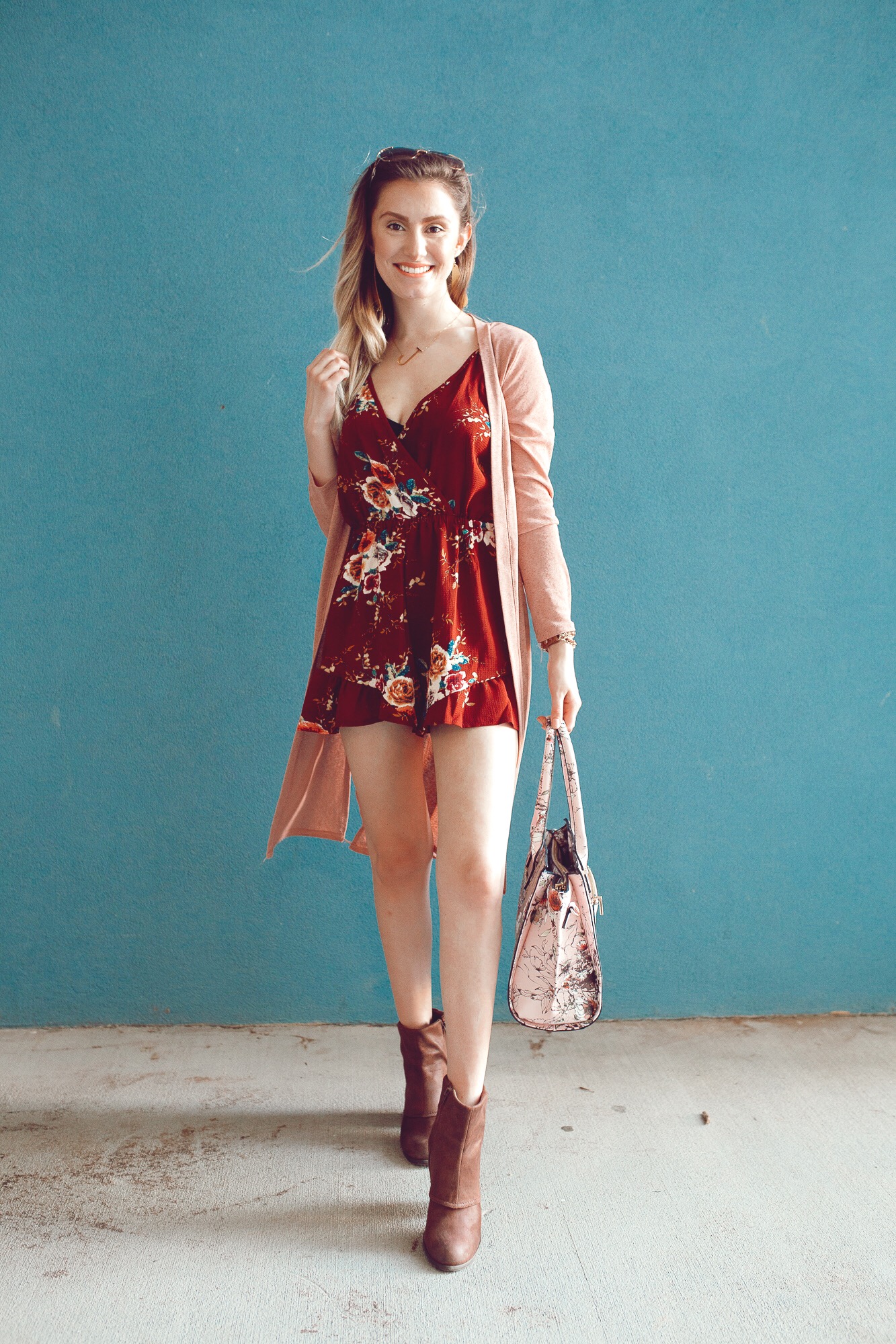 Summer to fall transition outfit by popular North Carolina fashion blogger Jessica Linn. Burgundy floral print romper from Copper Bloom, pink duster cardigan from Romwe, boots from Fergalicious by Fergie.