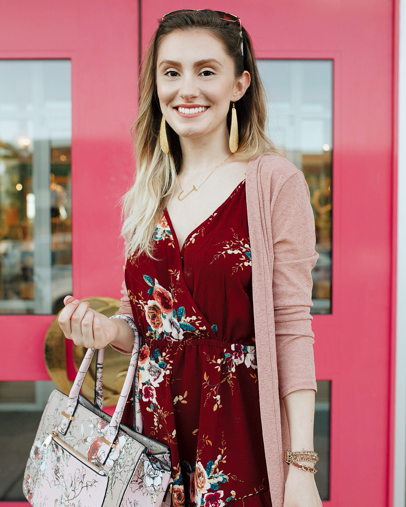 Summer to fall transition outfit by popular North Carolina fashion blogger Jessica Linn. Burgundy floral print romper from Copper Bloom, pink duster cardigan from Romwe, boots from Fergalicious by Fergie.