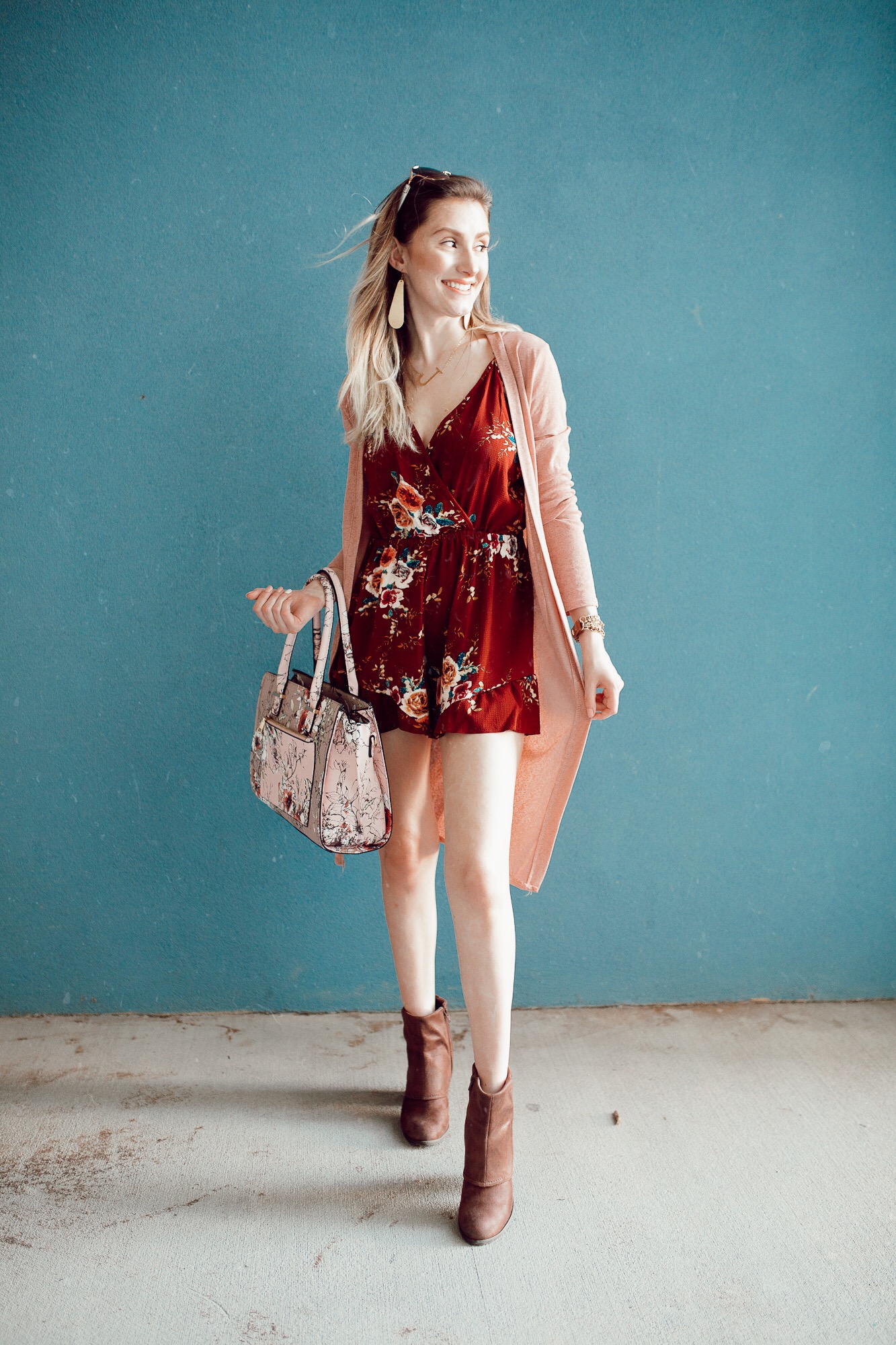 Summer to fall transition outfit by popular North Carolina fashion blogger Jessica Linn. Burgundy floral print romper from Copper Bloom, pink duster cardigan from Romwe, boots from Fergalicious by Fergie.