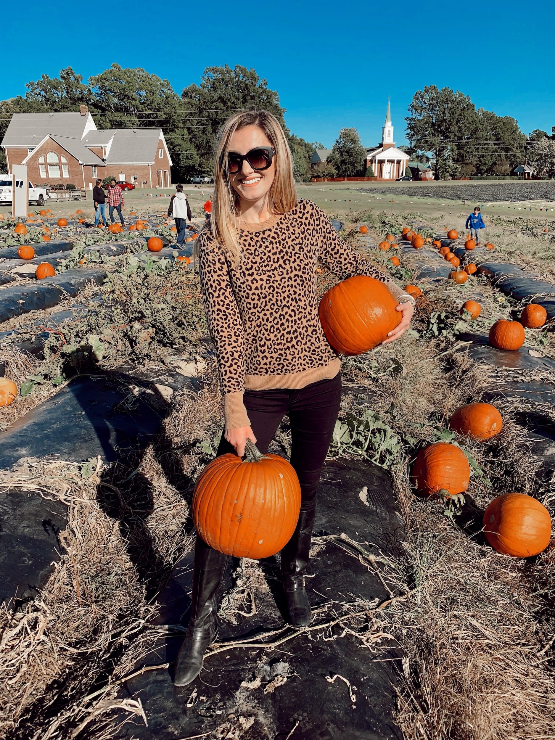 The $20 Target Pullover Sweater You'll Want In Every Print | North Carolina fashion and lifestyle blogger, Jessica Linn, wearing a leopard print pullover sweater from Target, black Charlotte Russe jeans, Ralph Lauren boots, and Eli Tahari sunglasses at Phillips Farm Cary NC.