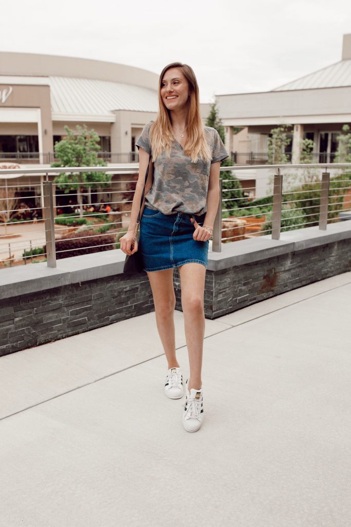 Sporty outfit inspiration with fashion blogger Jessica Linn wearing a Forever21 Denim skirt, Adidas shoes, and a camouflage t-shirt.
