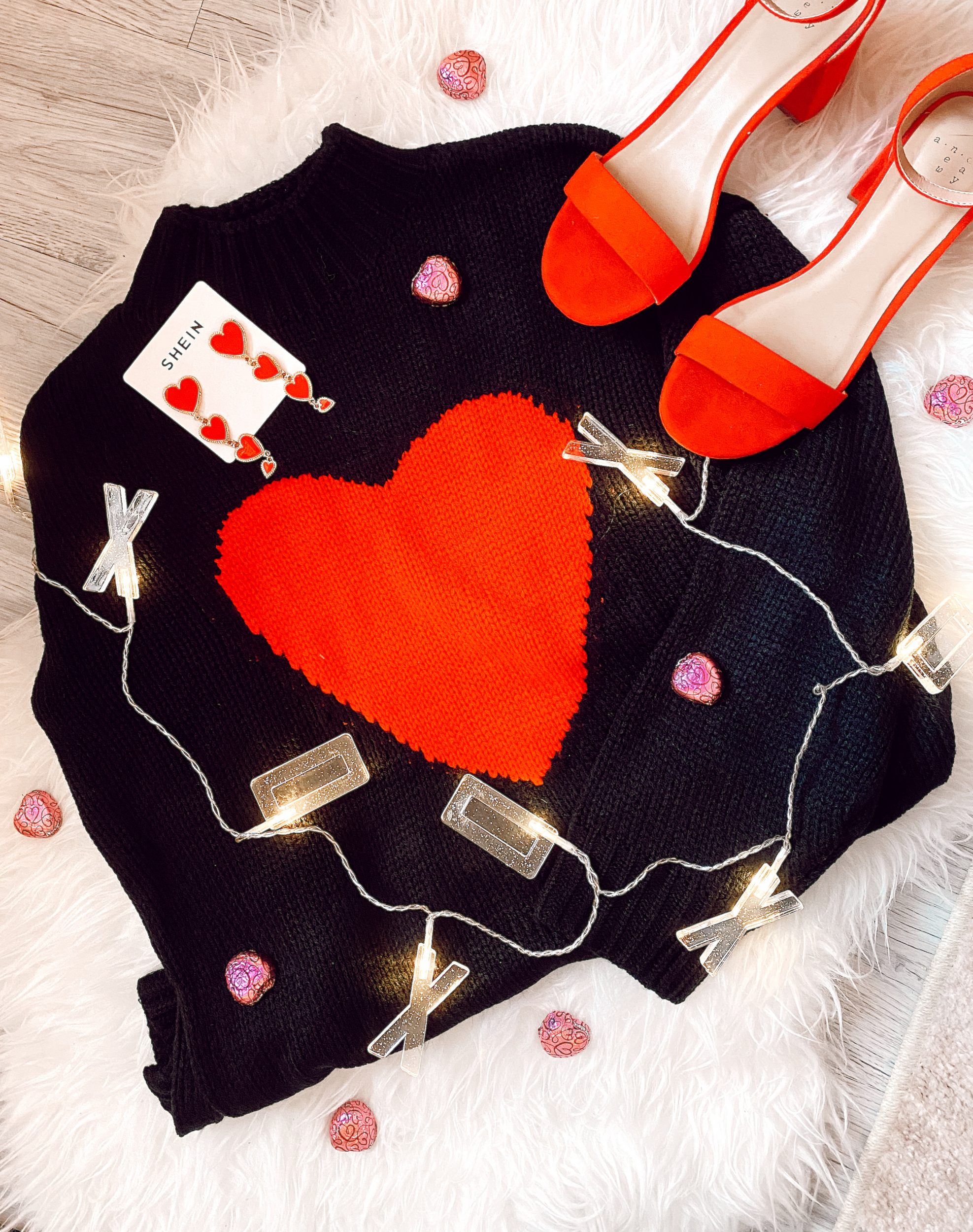 Heart Themed Outfits & Accessories For Valentine's Day By Jessica Linn owner of Linn Style Black and red heart sweater, red heart earrings, red heels.