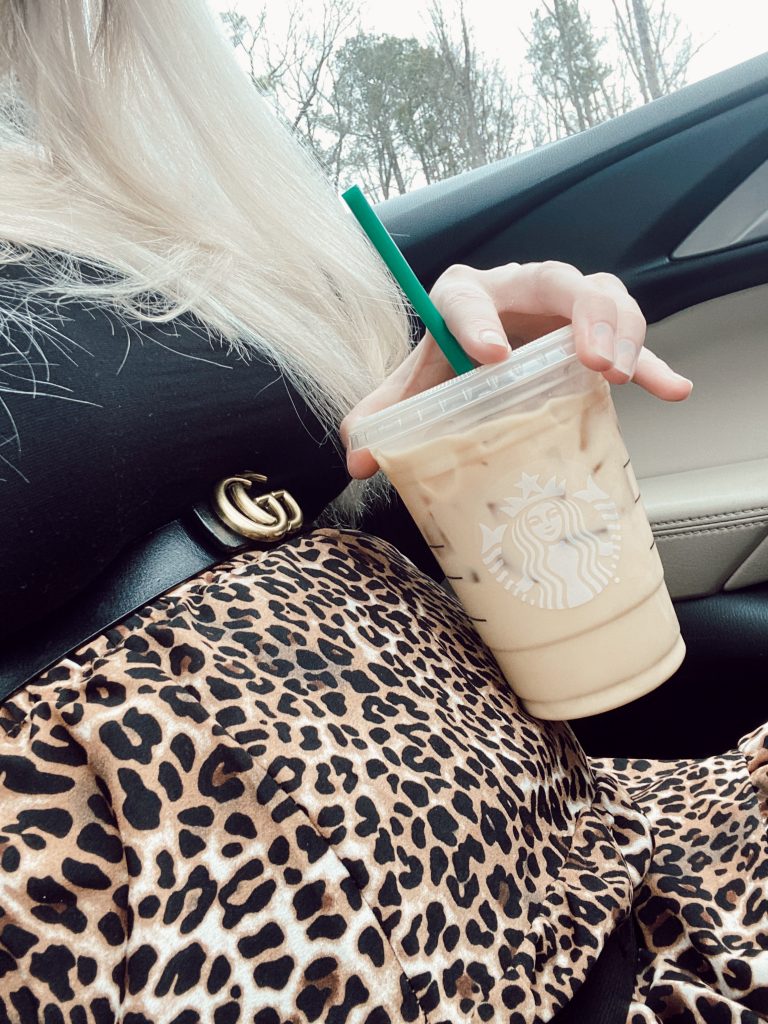 How To Wear A Non-Maternity Maxi Skirt While Pregnant by Jessica Linn.  Pregnant North Carolina fashion blogger Jessica Linn wearing a long leopard print skirt, black long sleeve shirt, and Gucci belt alternative with Starbucks blonde roast coconut milk latte.