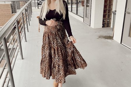 How To Wear A Non-Maternity Maxi Skirt While Pregnant by Jessica Linn. Pregnant North Carolina fashion blogger Jessica Linn wearing a long leopard print skirt, black long sleeve shirt, and wenda cut-out booties at Game on Escape Rooms.