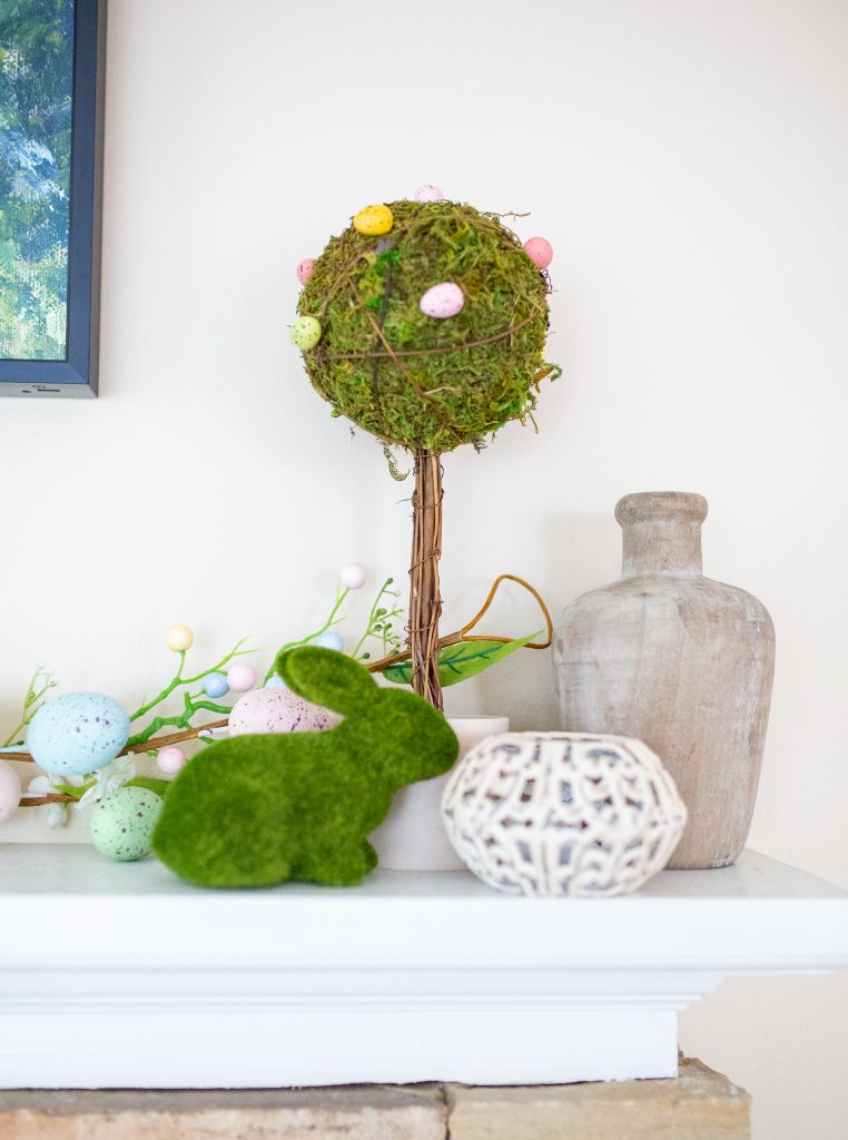 Simple Easter mantle decorations. Easter egg garland, egg topiaries